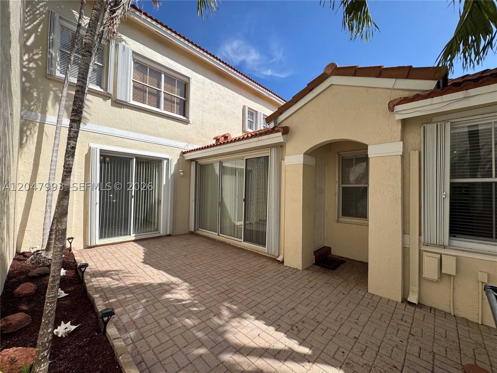 Charming townhome on tree-lined street in gated community close to beach & Downtown Hollywood. This model has two primary bedroom suites. Upstairs suite has vaulted ceiling and huge walk-in closet. Downstairs suite and living room area both have sliding doors that open up to paved courtyard. Eat-in kitchen has lots of windows. New wood-look vinyl flooring on first and second floor. Stack Washer/Dryer in unit. New roof. Accordian hurricane shutters. West Lake Village has heated pool, Jacuzzi, tennis and pickelball courts, exercise room, clubhouse, kids play area, and 24/7 security.