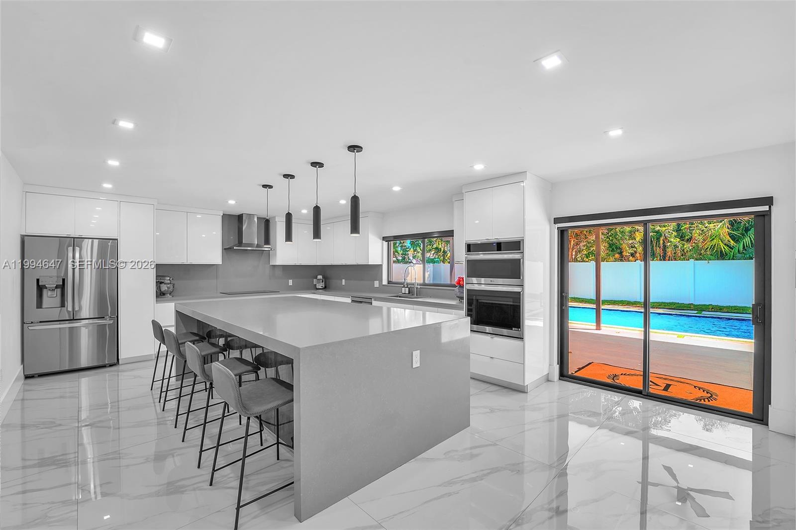 This is the one. Fully rebuilt 5BD/3BA on a rare estate-sized lot in Palmetto Bay. 2,696 SF, NO HOA, heated saltwater pool, and room for a pickleball court. New everything: electrical, plumbing, metal roof, 2 A/C units, water heater, concrete. All permitted. Zero deferred maintenance.
The kitchen will sell this home. A one-of-a-kind oversized island with built-in storage, integrated wine cooler & massive quartz countertop. Full suite of LG Smart appliances, modern cabinetry & open-concept flow into living and dining. You have to see this island in person.
Electric blinds on every window. Complete impact windows & doors. Porcelain tile throughout. Split-bedroom floorplan with two master suites, each with renovated en-suite baths & walk-in showers. New drywall, doors & designer light fixtures. Nothing left untouched.
The backyard is your private retreat: saltwater pool with heater, grass-paver accents & mature tropical landscaping. Oversized A/C 2-car garage with Tesla EV charger. Extended driveway for guests.
Minutes from Westminster Christian & Palmer Trinity. Near Old Cutler Rd & Deering Estate. Schedule your private showing before someone else does.