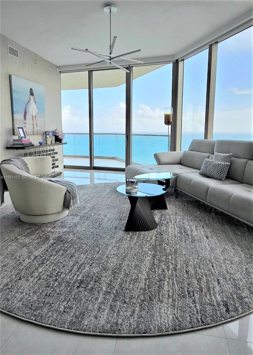 Experience breathtaking oceanfront and city views from this stunning high-floor corner residence. This elegant 2-bedroom, 2-bath condo with a spacious den features floor-to-ceiling windows that flood it with lots of natural light and showcase sweeping views in every direction.
Beautifully designed with neutral décor and sleek marble floors, the 1,608 sq ft layout offers an open, airy feel ideal for both relaxing and entertaining. The den provides flexible space for a home office, media room, or guest area. Step onto the wide, open balcony overlooking the ocean — a perfect extension of the living space and an ideal setting for morning coffee, sunset cocktails, or simply taking in the serene coastal backdrop.
A rare combination of corner exposure, and refined finishes makes this residence a standout opportunity for those seeking luxury living with unmatched views. Get ready to move in and enjoy!
oceanfront pool and landscaped terrace, private restaurant and bar, state-of-the-art fitness center and yoga studio, two-story spa with indoor/outdoor treatment rooms, wine cellar, cigar lounge, movie theater, club-style game room, children’s playroom, and exclusive beach services with attendants, food and beverage service, chaise lounges, and umbrellas, include 24-hour valet, 24-hour security, and concierge services.