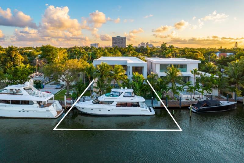 Experience elevated luxury in this newly built gated waterfront estate, nestled within the prestigious 24/7 guard-patrolled community of Belle Meade. Quietly positioned on a generous 10,710 SF lot, this smart home offers 6 bedrooms and 6.5 bathrooms across 6,902 SF of refined interior living space, thoughtfully designed for comfort and tranquility. A striking pivot door welcomes you into a dramatic 21-foot foyer, revealing expansive interiors with 11-foot ceilings and sleek modern finishes throughout. The main living areas flow seamlessly, anchored by a custom kitchen outfitted with Wolf and Sub-Zero appliances, elegant cabinetry, and a spacious walk-in pantry—perfect for both everyday living and entertaining. Designed for year-round enjoyment, the outdoor spaces feature a heated  pool, fully equipped summer kitchen, and covered lounge areas surrounded by lush tropical landscaping. With 70 feet of private dockage and direct access to Biscayne Bay with no fixed bridges, this property is ideal for boating enthusiasts. Blending privacy with contemporary design, this exceptional waterfront residence offers effortless sophistication just minutes from Miami’s Design District, beaches, and downtown—truly a modern coastal masterpiece.