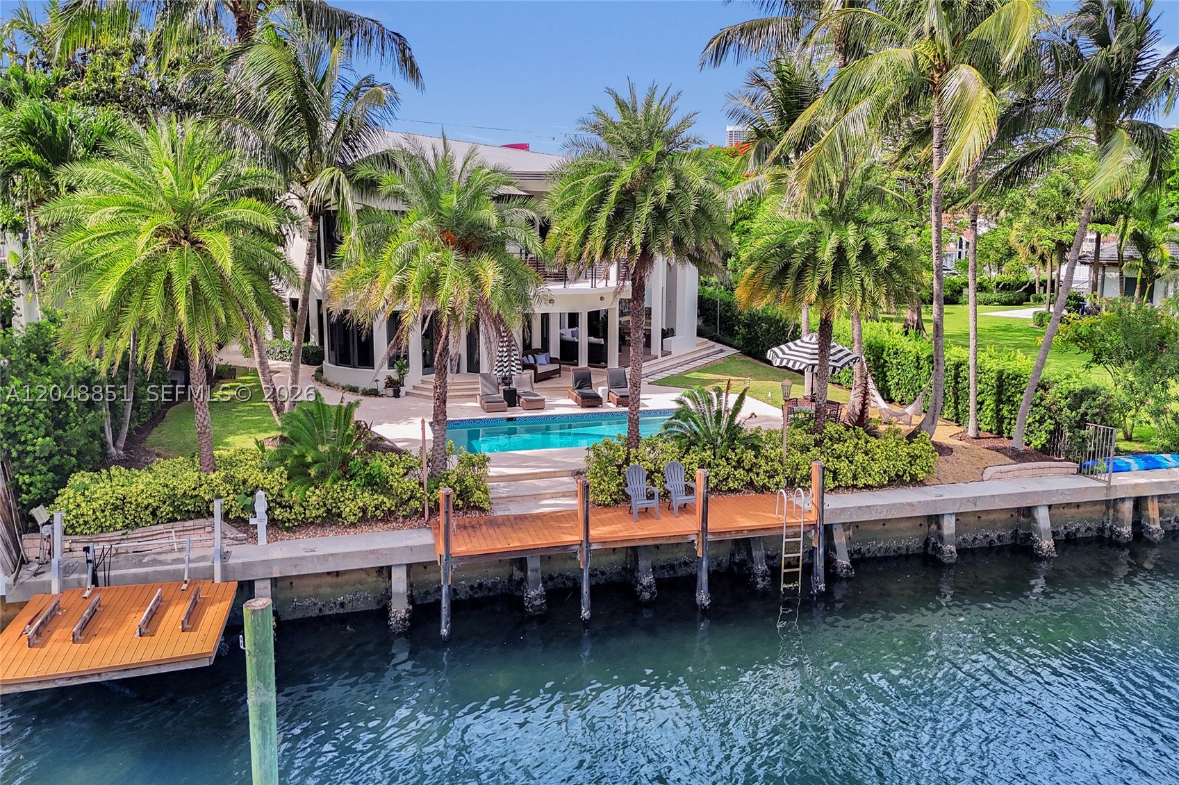 Imagine waking to open water views, stepping onto your private dock, and reaching the ocean within minutes. Set on the coveted second lot from the Intracoastal with 100 feet of prime waterfront, this exceptional estate delivers everything serious buyers seek: privacy, direct ocean access, and turnkey elegance. Beautifully reimagined, it offers 6 bedrooms and 7.5 baths, with 4 bedrooms upstairs and 2 conveniently located on the main level, designed both for grand entertaining and effortless everyday living.

Inside, soaring ceilings and a light-filled, open-concept layout create a bright, airy atmosphere where walls of glass blur the line between indoors and out. A centrally located private elevator connects every level with ease, offering both convenience and timeless luxury, while a state-of-the-art indoor and outdoor audio and video system sets the tone throughout the home.

The waterfront lifestyle here is truly uncompromised. A private dock, two Jet Ski lifts, and no fixed bridges place the open ocean a mere 20 minutes from your backyard. The outdoor living area features a resort-style heated pool, a full pool bath with shower, an expansive patio, and a large outdoor TV, with room to gather from sunrise mimosas to sunset cocktails.

A private second-floor gym completes the picture, delivering the ultimate South Florida waterfront lifestyle where refined design, effortless comfort, and open-water freedom meet. Schedule your private showing today.