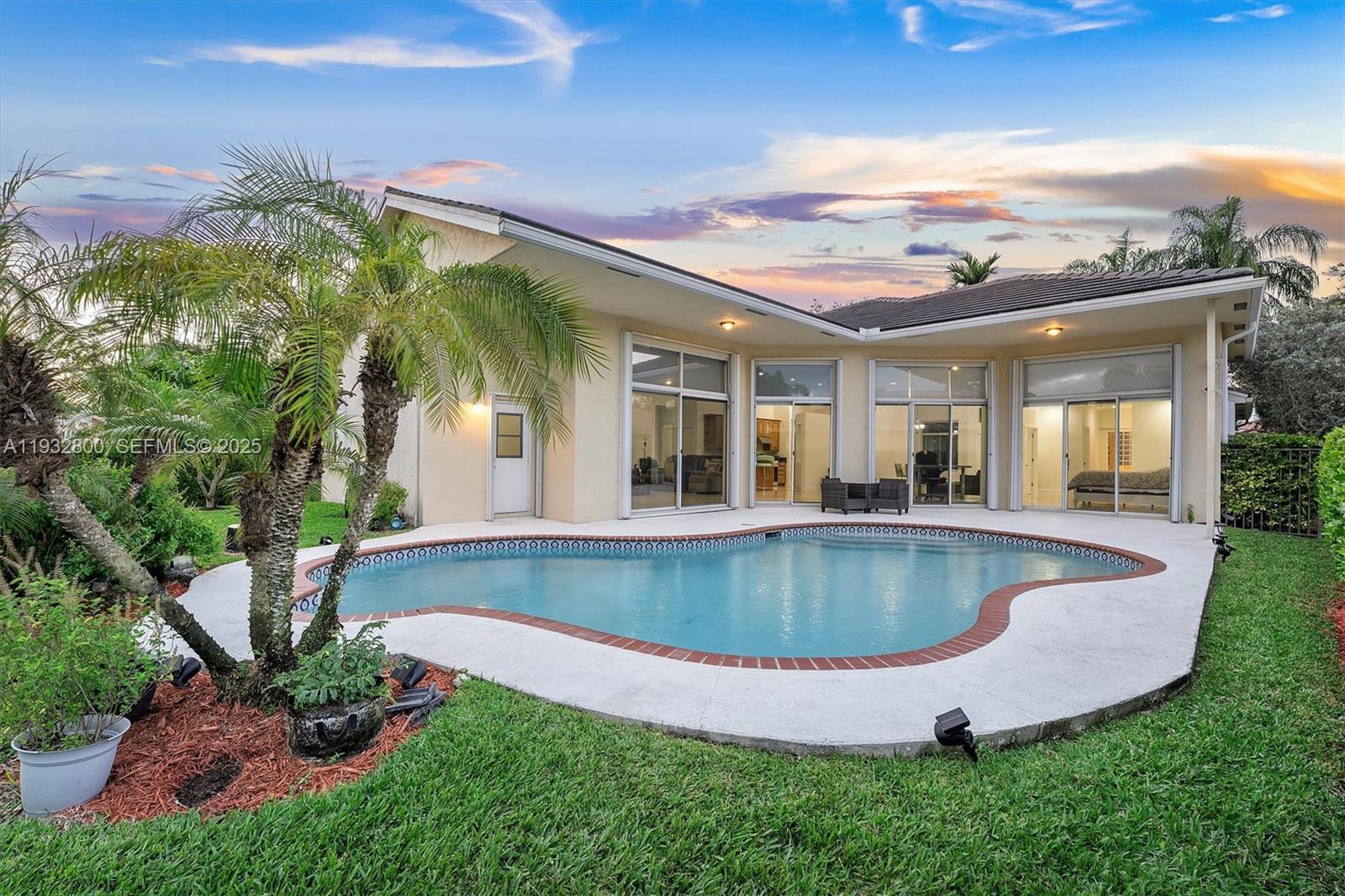 This beautifully maintained residence offers elegant one-level living in the prestigious gated community of Weston Hills. The home features bright and airy living and dining areas with an split floor plan, high ceilings, marble floors throughout, wood kitchen cabinets, granite countertops, stainless steel appliances, remodeled bathrooms, a 2-car garage, and accordion shutters. Enjoy the fully fenced backyard oasis with mango and papaya trees and a private swimming pool, perfect for outdoor entertaining. Recent updates include front and backyard landscaping, floor polishing, new living room window coverings, a new refrigerator, exhaust fan installation, kitchen filtration system, instant hot and cold water system, new microwave, new electric range, A/C (2018), water heater (2019), and roof (2015). Over the past three months, additional improvements include a new pool pump, power washing all windows, cleaning AC ducts, garage floor painting, gutter and roof cleaning, and sprinkler repair/replacement. Weston is a multicultural, family-friendly community surrounded by nature, palm trees, scenic lakes, and convenient shopping and dining. Residents enjoy A+ schools, golf courses, tennis centers, sports fields, and easy access to I-75. Recent community updates—fully funded by assessments paid off by the seller—include refreshed streets, sidewalks, and tree plantings in common areas. Mortgage savings may be available for buyers of this listing.