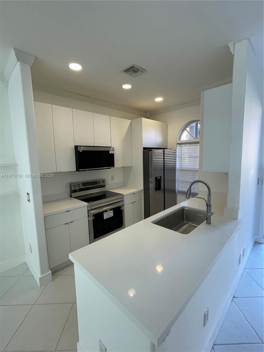Experience high-end living in this meticulously remodeled, turn-key residence. This stunning 3-bedroom, 2-bath home features a chef-inspired kitchen outfitted with brand-new Samsung stainless steel appliances, including a Wi-Fi-enabled freestanding electric range, dishwasher, microwave, and a side-by-side refrigerator with an external icemaker. The home is further elevated by an in-unit Samsung washer and dryer for ultimate convenience. Modern sophistication flows throughout with quartz countertops, fresh interior paint, and updated bathroom vanities. Enjoy the private, pressure-washed patio—perfect for outdoor relaxation. Modern luxury meets smart living!