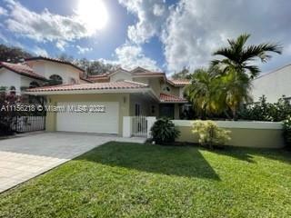 Spanish Villa style home surrounded by multimillion dollar homes! Beautiful treelined street and mature oaks abound! Dramatic high ceilings with recent impact windows & doors.Roof new in 2017! Foyer entry-step down Living Dining, lined by French doors with view of pool, patio & lovely back yard. White updated kitchen, island cooking, bay window breakfast area, wet bar and pantry storage room which opens to family room. One bedroom, bath and 1/2 bath on the first floor. 2 AC units, laundry room, washer & dryer, recent updated 2 car garage. Upstairs 2 bedrooms split from Master bedroom, bath, shower, dressing area & walk in closet. Master bedrm with backyard & pool view. New Cameras,intercom/radio sys & LED high hats installed. Paver DW, Child pool fence,Mango tree & mature Oak Tree!
