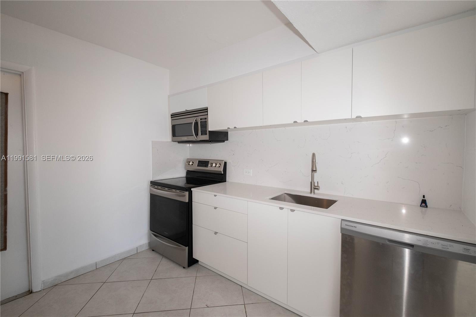 Bay Harbor Islands – Unit 403. Welcome to this bright and private top-floor condo in the heart of Bay Harbor Islands. This 2-bedroom, 1.5-bath residence features a beautiful open balcony with great views, perfect for enjoying the island breeze. The unit offers abundant natural light, a modern kitchen with stainless steel appliances, tile flooring throughout, updated bathrooms, and a spacious walk-in closet. It is quiet and private, with no shared common walls. Located in a gated community, the building includes a new elevator, swimming pool, assigned parking, additional storage, and pest control covered in the maintenance. Ideally situated within walking distance to top-rated schools—including one of the best schools in Miami-Dade just steps away—Bay Harbor Shops, restaurants, and just minutes from the beach. Currently rented, making it an excellent opportunity for investors or future end users. A rare find in one of the most desirable areas—don’t miss it! Tenant occupied, please call or text listing agent for showings with 24 hours’ notice.