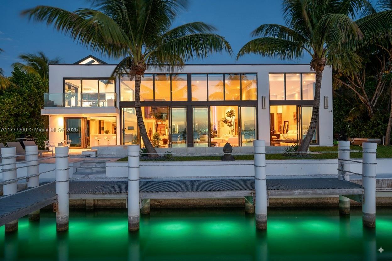 Welcome to an extraordinary waterfront retreat in the heart of the gated community of Biscayne Point Island, where stunning breathtaking wide water views capture unforgettable sunsets. Originally designed by renowned architect Barry Sugarman, this designer residence seamlessly blends modern waterfront living with a boater’s paradise. Featuring 98 feet of water frontage, this 5 bedroom, 6.5 bath residence is a sanctuary for boating enthusiasts, boasting a stunning primary suite, rare 16-foot-high ceilings, multiple entertaining spaces, and an expansive living room designed to impress. Thoughtfully crafted with sophistication and comfort in mind, the home exudes elegance and timeless charm.