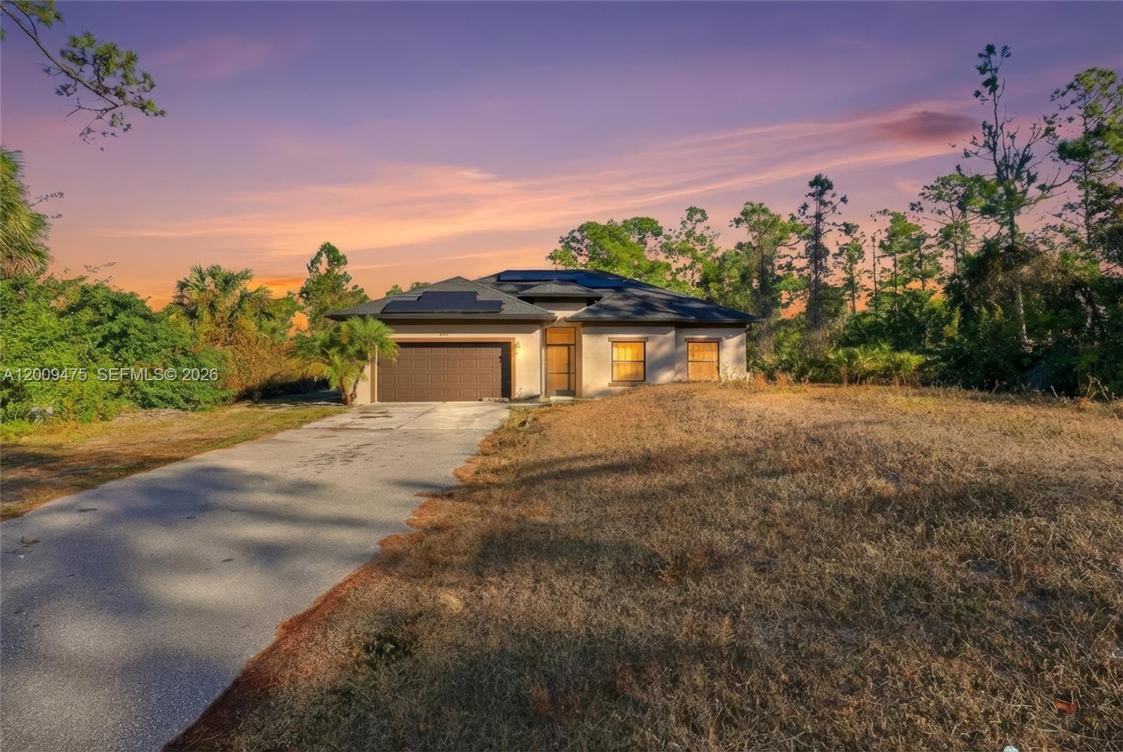 One or more photo(s) has been virtually staged, AI generated, or rendered. Discover this 3-bedroom, 2-bath single-family home built in 2019, situated on a 1.14-acre lot in the highly sought-after Golden Gate Estates. This move-in ready property features a bright and functional split-floor layout and includes solar panels, providing excellent energy efficiency and reduced utility costs. The home is equipped with a dual A/C system, offering enhanced comfort and efficient temperature control throughout the property. This property also includes an efficiency unit, ideal for generating additional rental income or easily converting into a fourth bedroom, guest suite, or private living space. The spacious primary suite features a dedicated office area, perfect for working from home or creating a private retreat. The lot is clean and cleared, offering ample space to build a custom pool, create your dream outdoor living area, or expand the property to suit your needs. Enjoy exceptional privacy and endless possibilities. Ideally located near key Naples destinations such as Publix at Randall Blvd, Founders Square, Corkscrew Island Regional Park, Ave Maria, top-rated schools, and just a short drive to shopping, dining, and Naples beaches.