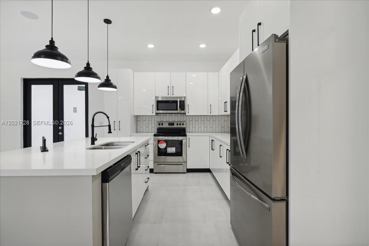 Beautiful Modern Home, on a spacious 1/2-acre lot, beautifully designed 3-bedroom + Den, 2-bath home offers approximately 1,613 sq ft of living space with modern finishes, high ceilings, and an open-concept layout ideal for everyday living and entertaining. The kitchen features sleek cabinetry, stainless steel appliances, and ample counter space, flowing seamlessly into the bright open living and dining areas. The spacious primary suite offers comfort and privacy, while the additional bedrooms provide flexibility for guests, a home office, or growing needs. Enjoy Florida outdoor living year-round with an oversized patio and plenty of backyard space to create your dream outdoor oasis, add a pool, park recreational vehicles, or simply enjoy the extra privacy and room to spread out. Built in 2023 with quality upgrades including impact windows and doors, a 3.5-ton central AC system, this home combines style and peace of mind. Conveniently located near shopping, dining, schools, parks, and major roadways with easy access throughout Southwest Florida. A great opportunity for a primary residence, seasonal home, or investment property. Schedule your private showing today!
