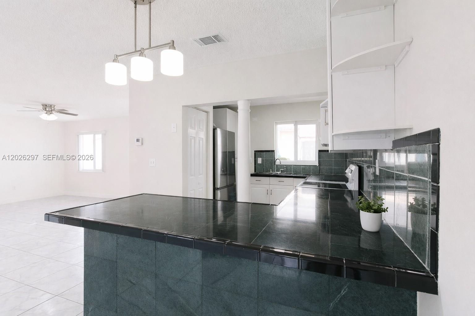 Spacious 3-bedroom, 2.5-bathroom single-family home on a desirable corner lot in the City of Sweetwater. This two-story residence features a tile roof, open-concept kitchen with a breakfast bar, white cabinetry, tile countertops, and two refrigerators, including a stainless steel unit, fully equipped with impact-resistant windows and doors. Enjoy generous covered patio areas, perfect for entertaining or relaxing, with ceiling fans and plenty of space for gatherings. Tile flooring throughout. Corner lot provides ample parking and added privacy. No HOA fees! Conveniently located near Florida International University, Dolphin Mall, major expressways, restaurants, and shopping. Seller is offering up to $25,000 toward buyer’s closing costs. Sold AS-IS. Great opportunity for investors or buyers looking to add their personal touch. Don’t miss it!