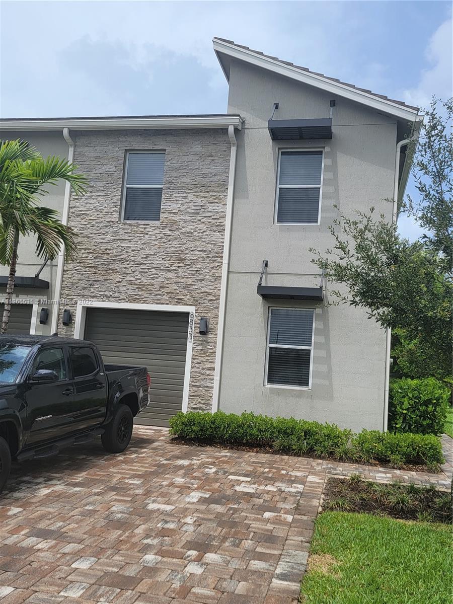 Brand New Townhouse! 4/3 corner unit with a one car garage plus double driveway and covered lanai with pavers and it even has smart home features for lights, locks & more. The main bedroom & 3 additional bedrooms plus a loft. Full-size washer and dryer are upstairs with full bath downstairs. Brand New appliances & only a few homes from the community pool and mailboxes. Excellent location, conveniently located within walking distance to shopping centers, Publix, Dunkin Donuts and more. You won't want to miss this one it's a must-see!