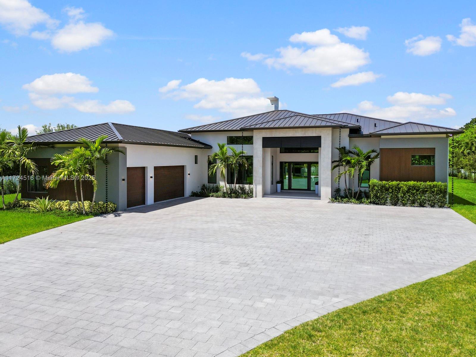 Completed in 2025, this newly built custom estate sits on over an acre, offering 7,471 sqft of refined modern living. Thoughtfully designed for today’s families, it features soaring 17-ft ceilings, fireplace, gourmet kitchen, maid’s quarters & a versatile playroom or office. The open and light-filled spaces flow effortlessly to the outdoors. Perfect for entertaining, the expansive terrace, summer kitchen, and resort-style pool with jacuzzi create a seamless setting for gatherings and relaxation. The split layout provides exceptional comfort and privacy, while the 3-car garage and large driveway offer ample space for vehicles, boats, or an RV. Built with timeless elegance and attention to detail, this home delivers the perfect balance of luxury, functionality, and serenity.