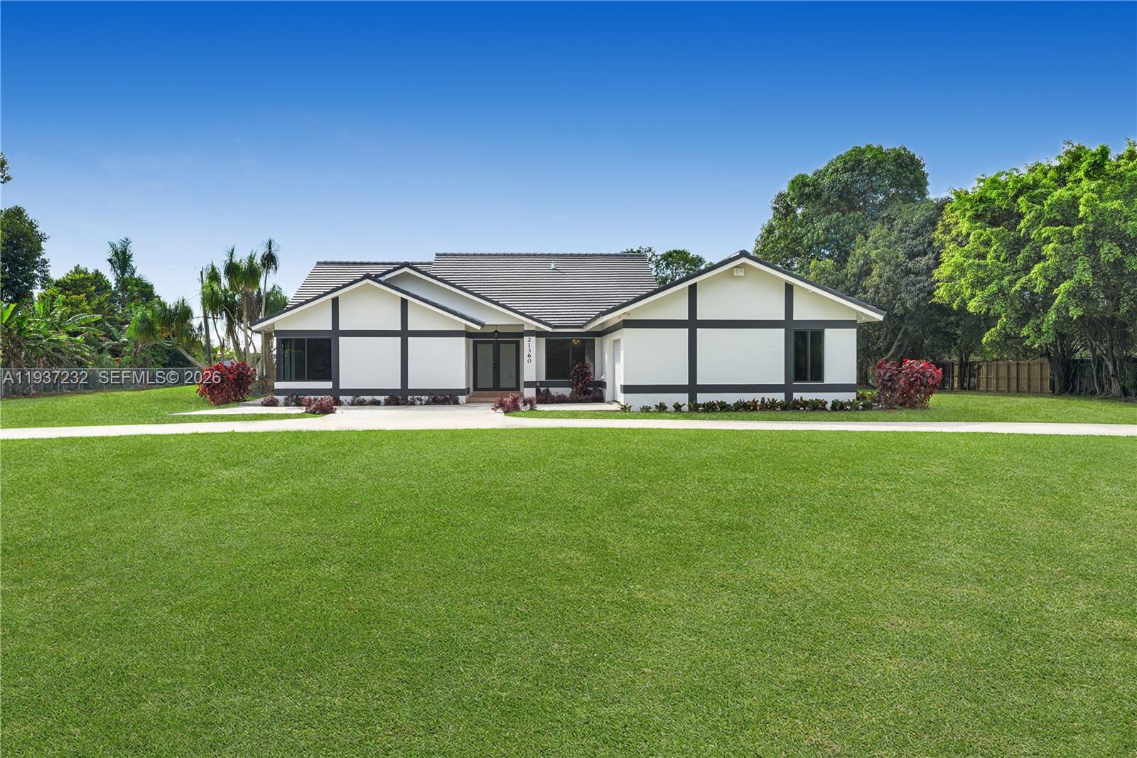 Some properties just have it. That rare mix of land, air, and elbow room that reminds you why people fell in love with South Florida before the condos came. This 3,194 sq ft ranch-style estate on 1.25 private acres in the heart of Homestead's Redlands is exactly that kind of place.

Built in 1993 and fully renovated, this 4 bedroom, 3.5 bath home sits in one of Miami-Dade's last true agricultural enclaves, where your neighbors are mango groves, not walls. The open floor plan flows naturally from kitchen to dining to living, the kind of layout that handles a Sunday family dinner and a quiet Tuesday night with equal grace. Four generous bedrooms give everyone their own space. The land gives you the rest.
Built for South Florida life:

Impact-rated glass on every window and door; storm season ready, year-round peace of mind
Dual electric gates; private, secure, and gated before gated was a trend
Fully renovated throughout; move in and enjoy.

Top-rated schools nearby. This is Miami-Dade's last true agricultural lifestyle; land, privacy, and room to breathe. Come see why the Redlands still feels like home.

You're 30 minutes from Kendall, 40 from MIA, and walking distance in spirit from Knaus Berry Farm, Fruit & Spice Park, and Bonanza Estates Park. Krome Ave, the Turnpike, and US-1 keep you connected when you need to be.

But out here, you won't always need to be.

-----
DISCLAIMER : THIS PROPERTY IS VIRTUALLY STAGED