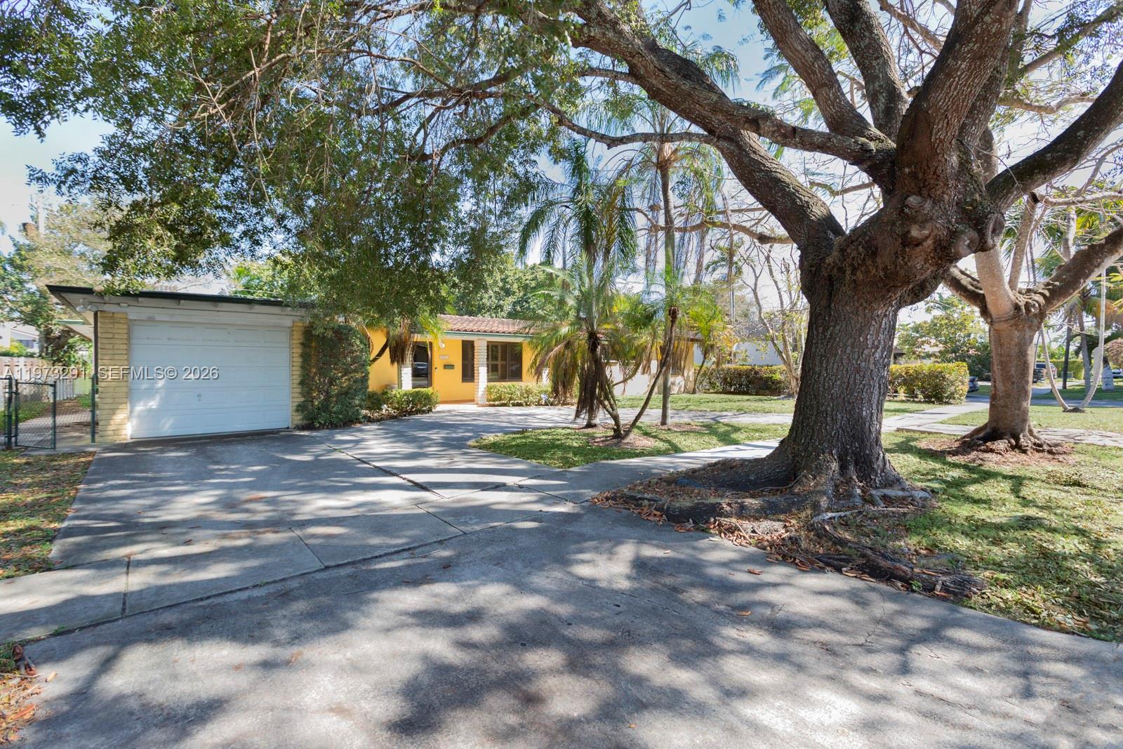This 3-bedroom, 3-bathroom single-family residence sits on an oversized double lot of over 10,000 square feet in a prime Miami location, just south of Schenley Park and immediately west of Coral Gables, near the intersection of Red Road and Bird Road.

The home features impact windows and an updated kitchen, blending character with modern improvements. Vaulted ceilings with beautifully exposed wood beams create warmth and architectural charm throughout the main living areas and bedrooms. A spacious Florida/family room opens to a large terrace overlooking the expansive backyard, offering ample space for a pool, future expansion, or both.

The third bedroom is configured as a private in-law suite or studio apartment, complete with its own kitchen, closet, and separate entrance, ideal for extended family, guests, or rental income potential.

Additional highlights include a generator, one-car garage, and a dedicated utility/laundry room.