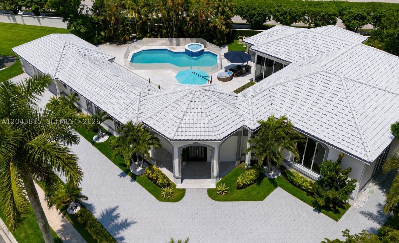 Rarely Available in Grand Oaks — the Premier Estate Enclave of Broken Sound Country Club. Situated on a builder’s acre lot, this fully transformed one-story courtyard estate offers a rare combination of space & privacy. Designed for today’s buyer, this 6BR/6BA residence features soaring ceilings, dramatic floor-to-ceiling glass showcasing lush tropical views, an open-concept design, and an oversized kitchen island rarely found. The main residence is complemented by a fully renovated detached 2BR/2BA guest house, ideal for extended family, guests, or a private retreat. Expansive grounds feature a resort-style pool, oversized circular driveway ,3 car garage & exceptional outdoor space with endless possibilities to expand. Behind the gates of Broken Sound, enjoy two championship golf courses, world-class tennis, fine dining, spa, wellness amenities in one of Boca Raton’s most sought-after private country club lifestyles.
