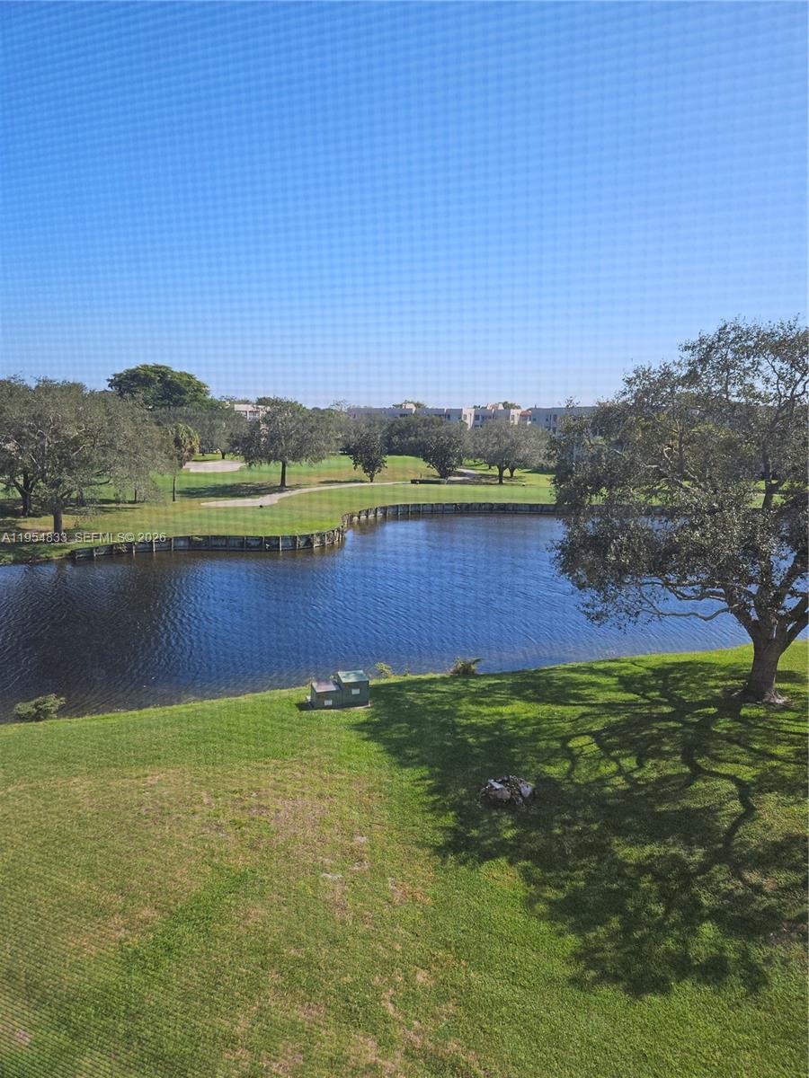 PRICE ADJUSTMENT! Surrounded by decades old trees, there is a peaceful, beautiful feeling living in this great Davie condo. Prime location 1/1 unit located in the Pine Island Ridge community of Live Oak. WOW! That describes this cozy condo to a TEE! Wood floors and cabinetry is a warm honey color, accented with granite countertops in the kitchen and bath. This condo is 5 yrs young - electrical panel, appliances, flooring and fixtures.  Can be sold furnished and includes Pride appliance, electrical and plumbing service contract. Large windows in the living area flood the rooms with light. Relax on your balcony watching the golfers pass by; or sun at the pool just next door. Assigned parking for one car; plenty of guest parking too. Includes storage space and on-site laundry steps from your door. Ideal location to get to Ft Laud/Hollywood Airport; I595, FL Turnpike; shopping includes - Publix, Trader Joes, Costco, Home Depot, and great restaurants - Flanagan's, Twin Peaks, Panera, Tap 42, Longhorn just to mention a few! The cherry on top is all residents are members of Pine Island Ridge Country Club with 2 restaurants, heated pool, gym, golf course, tennis and more. This unit is ready for its new owner - could it be YOU? Come, See and Stay.