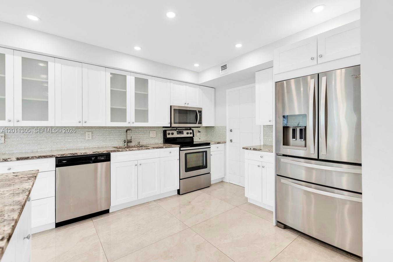 PRICED TO SELL! Enjoy stunning water views in this renovated condo. The open-concept layout features porcelain floors, a modern kitchen with granite countertops, backsplash, cooking island, stainless steel appliances, food disposer, smart AC control and security camera. The master suite is designed for comfort, the bathrooms are updated with marble countertops, glass shower doors, and a dual-sink in the master bath. Relax on the screened balcony and enjoy natural light throughout, along with impact windows and doors, plenty of closet space, and extra ground-floor storage. Resort-style amenities include a waterfront pool, fitness center, saunas, game room, laundry facilities on each floor, and a sundeck with barbecue grills. Just one mile from the beach and minutes from shopping, dining, and entertainment.