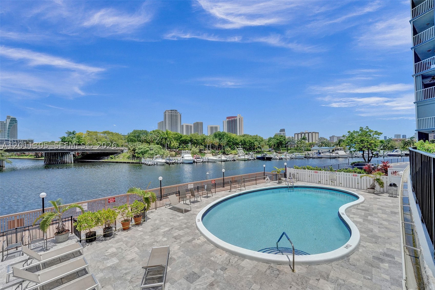 PRICED TO SELL! Enjoy stunning water views in this renovated condo. The open-concept layout features porcelain floors, a modern kitchen with granite countertops, backsplash, cooking island, stainless steel appliances, food disposer, smart AC control and security camera. The master suite is designed for comfort, the bathrooms are updated with marble countertops, glass shower doors, and a dual-sink in the master bath. Relax on the screened balcony and enjoy natural light throughout, along with impact windows and doors, plenty of closet space, and extra ground-floor storage. Resort-style amenities include a waterfront pool, fitness center, saunas, game room, laundry facilities on each floor, and a sundeck with barbecue grills. Just one mile from the beach and minutes from shopping, dining, and entertainment.