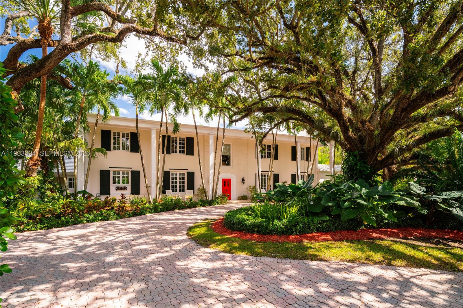 Tucked within the exclusive, gated enclave of Ponce Road Estates—home to only five residences—this Ponce-Davis estate is truly the crown jewel. Set on a generous 3 / 4-acre lot, the 6-bedroom residence (plus home office) showcases exquisite craftsmanship and thoughtful details at every turn. Refined moldings, impact glass, a beautifully remodeled island kitchen with Viking gas range, dual ovens, dual sinks, and a walk-in pantry, along with tastefully updated bathrooms, speak to its elevated design. The primary suite is Architectural Digest–worthy, featuring a spa-inspired bath and an enviable, Instagram-ready closet. Enjoy movie nights in the private media room, morning workouts in the gym, or al fresco gatherings on expansive terraces and balconies overlooking lush, mature gardens. The pool, patio, and summer kitchen create an idyllic backdrop for unforgettable entertaining. An oversized two-car garage and covered carport add convenience, while the community’s own tennis, pickleball, and basketball court complete this rare offering. Located within the super desirable A+ rated Sunset Elementary School. Per appraisers calculations, total living area is 5,521', total adjusted area is 6,313' and  total area under roof is 7,937'.  A Very Special Home.