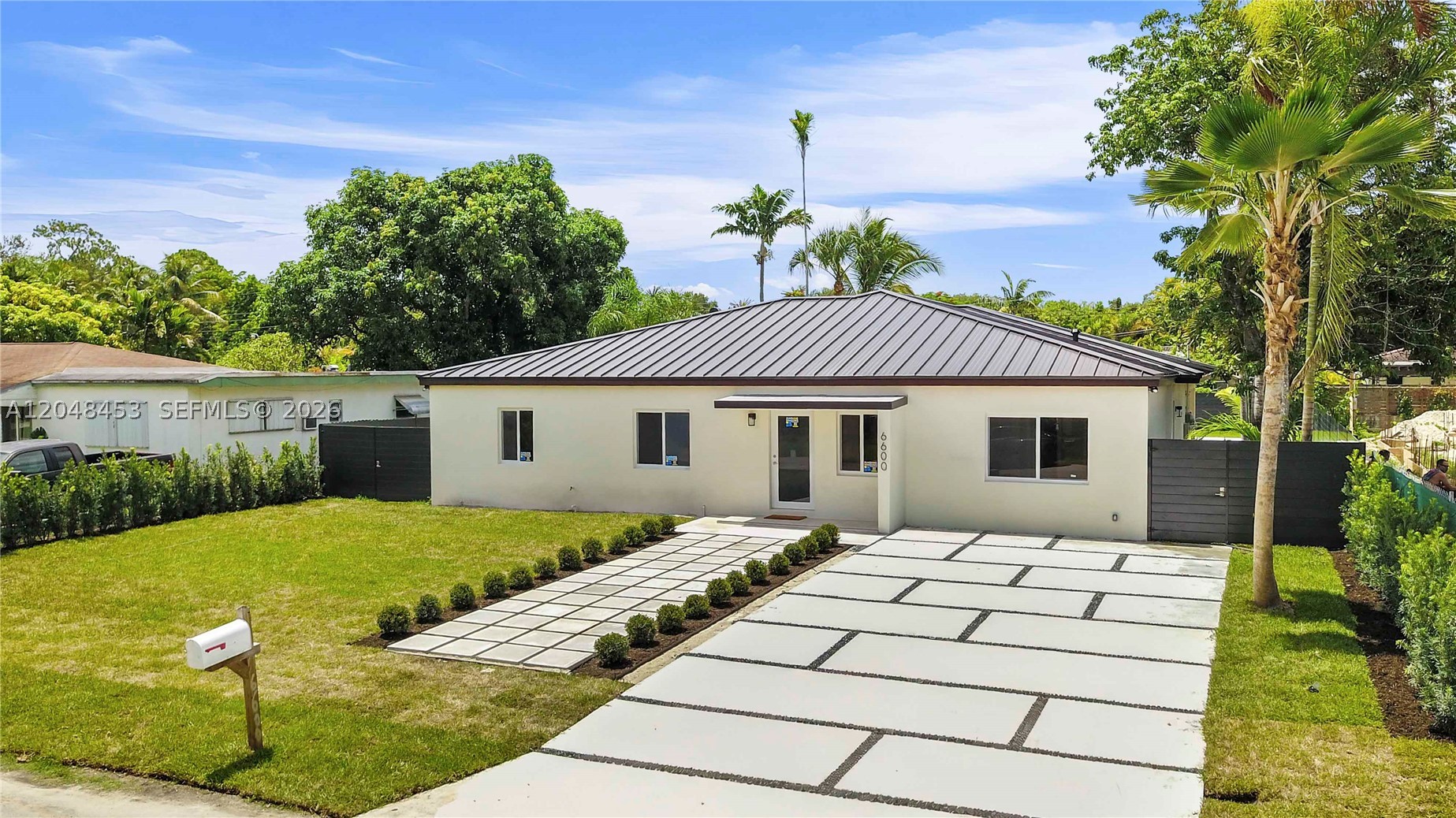 Brand new property in Bird Rd Terrace 4 bed/3 baths with 2,065 sq. ft. under air and 2,640 sq. ft. of total construction with a 15’ x 30’ pool and a 550+ sq. ft. terrace. This house was built on an 11,000 sq. ft. lot. Brand new electric, plumbing, AC, and metal roof. This stunning, turn-key residence has been completely transformed with immaculate modern finishes throughout. Features a durable, contemporary metal roof and impact windows that fill the home with natural light. Step inside to an open and airy layout boasting neutral porcelain tile flooring, recessed LED lighting, and crisp, clean lines. The primary and secondary bathrooms are beautifully designed with floating wood vanities, chic matte fixtures, custom floor-to-ceiling tile work, and seamless glass showers. A dedicated laundry room comes fully equipped with a modern front-load washer/dryer set and a utility sink. Perfect for remote work or a growing family, the layout includes bright, versatile bedrooms/office spaces with ample closet space. Step outside to your ultimate backyard retreat, featuring a sparkling, pristine pool surrounded by an expansive pool deck, lush green grass, and towering palm trees—ideal for entertaining or relaxing in total privacy. Don't miss this move-in ready gem!
