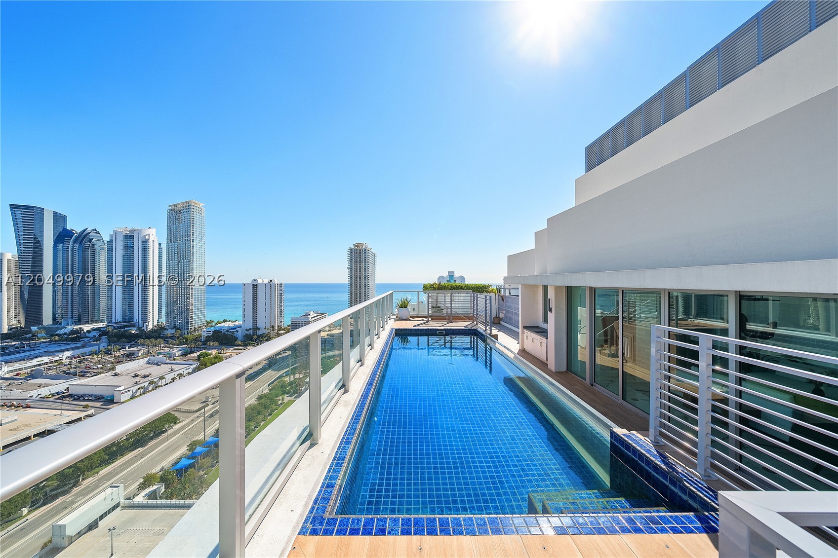 PRICED FOR IMMEDIATE SALE THE PENTHOUSE TOWER SUITE AT THE CROWN OF PARQUE TOWERS, MOMENTS FROM THE BEACH! Priced Under Market Value… Experience the pinnacle of turnkey luxury in this stunning, state-of-the-art Upper Penthouse spanning 3,722 SF + Stunning MASSIVE Private Rooftop Deck with Private Glass Pool Overlooking the Skyline & Ocean. This extraordinary residence offers breathtaking views of Sunny Isles Beach skyline and the ocean. This modern gem features 5 Bedrooms & 5.5 elegantly designed Bathrooms. The top-of-the-line chef’s kitchen is outfitted with premium Wolf, Sub-Zero, and Bosch appliances, complemented by exquisite marble and Adamantium quartzite countertops. Designed for seamless Indoor-Outdoor living, the home boasts expansive balcony and Rooftop patio spaces, along with a private upper-level deck. From this elevated retreat, enjoy sweeping NE and NW views of Miami, with majestic ocean vistas, an entertainer’s dream. 4 Parking Spaces + Deeded Massive Storage Unit. Parque Towers features 5-Star Amenities… Poolside Bar & Bistro, poolside cabanas, private cinema and game room, spa & fitness center, hotel-style guest suites, and a Kids Club, 24-hour security + front desk & valet.