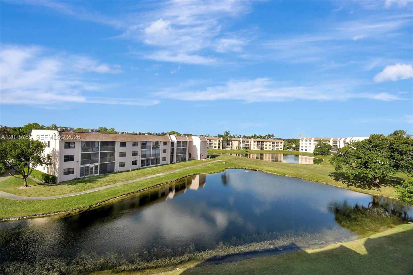 Experience elevated South Florida living in this beautifully remodeled top floor residence located within a highly desirable 55+ community. Wake up to serene golf and water views from the oversized enclosed patio, the perfect space to enjoy your morning coffee or unwind at sunset. Conveniently positioned near the elevator with a premium parking space just steps from the entrance.  New roof, New elevator, New catwalk. Designed with comfort and style in mind, this spacious move in ready home showcases waterproof laminate flooring, fresh modern paint, updated guest bath, ceiling fans, washer/dryer, updated electric water heater, and newer kitchen appliances including a sleek refrigerator. The upgraded 2 ton A/C system features Reme Halo UV air purification, enhanced climate control, and recently cleaned ductwork for added peace of mind and energy efficiency. Enjoy a vibrant resort style lifestyle with access to a renovated clubhouse, heated pool, sauna, billiards, tennis, pickleball, fitness amenities, social activities, and more. Mortgage assumption may be an option for qualified buyers. Association requires minimum $3,000 monthly net income and 700+ credit score. No leasing or corporate ownership permitted. Shown by appointment only; no showings after 6 PM.