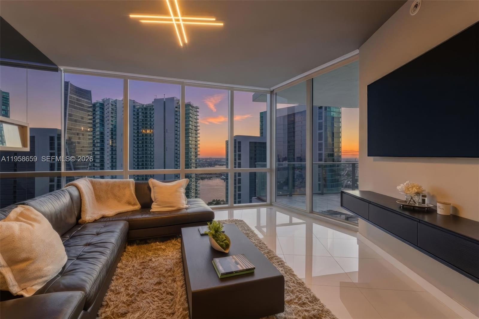 STUNNING water+ bay views, high-floor, and a beautifully upgraded interior, all offered as one of the best-priced residences in the building!
Residence 4303 at Paramount Miami Worldcenter delivers a refined, design forward living experience high above the city with expansive covered balcony and private elevator entrance. This premium residence features a striking glass wall fireplace, custom drop ceilings with integrated LED lighting, exterior balcony LED lighting for evening ambiance, and fully built-out custom closets, offering a truly turnkey opportunity.
Located within Miami Worldcenter, Paramount offers unmatched walkability and long-term value. Residents are steps from world-class shopping, dining, and entertainment including the Apple Store, Lucky Strike Bowling, Club Studio, Sephora, and Maple & Ash. Waterfront Museum Park is within walking distance, while immediate access to the Kaseya Center places concerts and sporting events just outside your door!! 
The building is known for one of the most expansive amenity collections in Miami, featuring a resort-style pool deck, 5 total pools, two-story fitness and wellness facilities, spa with sauna and massage rooms, theater, golf simulator, boxing ring, basketball court, yoga and boxing studios, private lounges, co-working spaces, children’s play areas, and 24-hour concierge, valet, and security. Less than 10 minutes from Brickell and under 15 minutes to Miami International Airport.