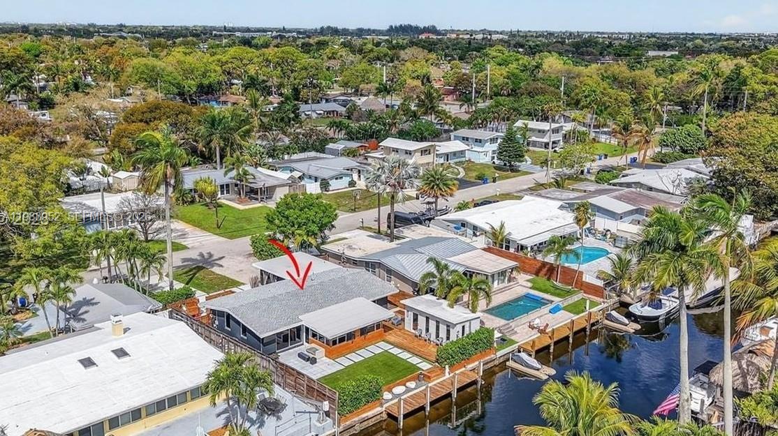 Completely renovated waterfront home in Lauderdale Isles with ocean access and no fixed bridges. This 3BD/2BA home includes an additional 200' sq ft shed completely enclosed with drywall & recessed lighting. Fully reconstructed with permits: Roof (2024), new electrical lines/panels. New plumbing throughout including underground PVC lines, and tankless water heater. Open layout with vaulted ceilings. Beautifully renovated kitchen featuring a large island, white cabinetry, granite counters, and 36 inch double Subzero fridge & freezer—ideal for entertaining. Large flex space in primary bedroom ideal for custom closet build out & gym/office - bath with rain shower & fireplace over stand alone bathtub. Impact windows and doors!! New plank laminate flooring installed throughout main living areas. AC 2023. Elegant front courtyard entry offers privacy and tranquility. Enjoy 60’ of waterfront with dock equipped with 30/50 amp shore power. Stunning outdoor space with artificial turf, pavers, and firepit. Large driveway intentionally designed for RV/boat parking with two EV chargers. No HOA. Prime location near 595, I-95, FLL Airport, Las Olas, and quick boat access to the New River and Fort Lauderdale Beach. Seller financing available!!