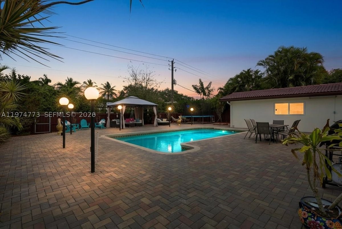 Welcome to this exceptional 4-bedroom, 3-bath pool home located in the highly desirable Hollywood Hills neighborhood, conveniently located in central Hollywood. The home features impact windows and doors, polished porcelain tile flooring throughout, and smooth-coated ceilings accented by modern LED lighting for a bright, contemporary feel. The beautifully remodeled kitchen features real wood cabinetry, granite countertops, and stainless steel appliances, perfect for both everyday living and entertaining.

All three bathrooms have been fully renovated, showcasing elegant travertine finishes and frameless glass shower doors. Outside, the resort-style large pool area is an entertainer’s dream, boasting over 3,400 square feet of pavers, ideal for gatherings, lounging, and outdoor dining. The fully fenced, private lot offers both tranquility and security. Meticulously maintained and move-in ready, this home blends style, comfort, and functionality in one of Hollywood’s most sought-after neighborhoods.  All information is deemed to be reliable, but verified by Realtor.
Open house on Sunday March 15th 1-4pm