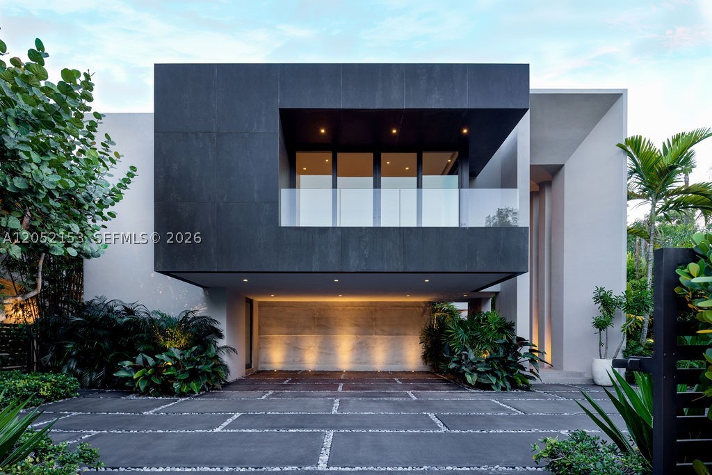 Featured on the cover of Luxe Magazine, this architect owned Coconut Grove residence is a rare expression of thoughtful design and exceptional craftsmanship. Conceived, designed, and built by its owner, an architect and general contractor with more than 40 years of experience, the 3,100 SF home embraces Miami's signature indoor outdoor lifestyle with timeless architecture.

23 foot ceilings, wide plank European white oak floors, custom walnut millwork, and walls of impact resistant glass fill the home with natural light and connect the interiors to the surrounding tropical landscape.

The Mia Cucina chef's kitchen features Sub Zero and Wolf appliances, custom cabinetry, and a dramatic 14 foot Calacatta Gold marble island, flowing into the open living spaces and outdoor entertaining areas.

The private backyard offers a heated pool and spa, summer kitchen, outdoor shower, and lush tropical landscaping, creating an exceptional setting for year round outdoor living.

Modern conveniences include a smart home system, Lutron lighting, automated shades, impact resistant glass, and a full home generator.

Ideally located in the heart of Coconut Grove, moments from waterfront parks, marinas, acclaimed restaurants, and boutique shopping, this exceptional residence offers a lifestyle that is distinctly Grove. Homes personally designed and built by accomplished architects rarely become available, making this a rare opportunity to own a residence created without compromise.