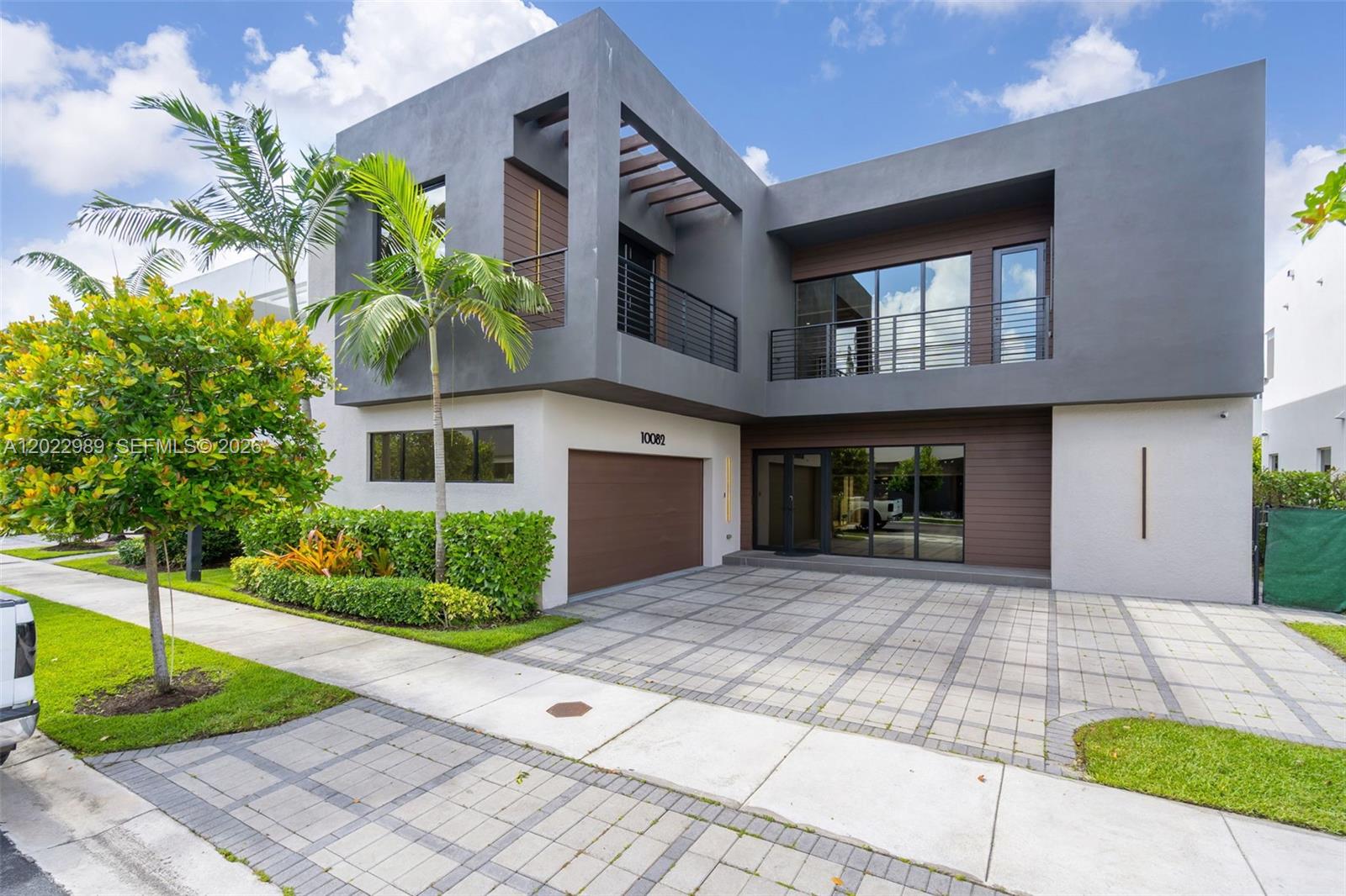Welcome to one of the most iconic communities in Doral. This luxury contemporary single-family home features 5 bedrooms and 5 bathrooms, offering spacious living areas and modern finishes throughout.

The first floor includes a bedroom with a Murphy bed, ideal for guests or a private office, along with a full bathroom with direct patio access. The Italian-style kitchen is equipped with quartz countertops, Bosch appliances, and a wine cooler. The family room showcases custom upgrades, including a built-in bar and additional pantry space.

Porcelain flooring on the first level, along with wood stairs and wood flooring throughout the second floor, adds warmth and elegance. Solid concrete construction with impact windows and doors provides durability and peace of mind. The primary suite features dual walk-in closets, a Roman tub, and a separate shower.

Exterior highlights include a renovated façade, private pool, and BBQ area, perfect for entertaining. Two-car garage plus additional parking for three vehicles. Located in a gated community with 24/7 security.