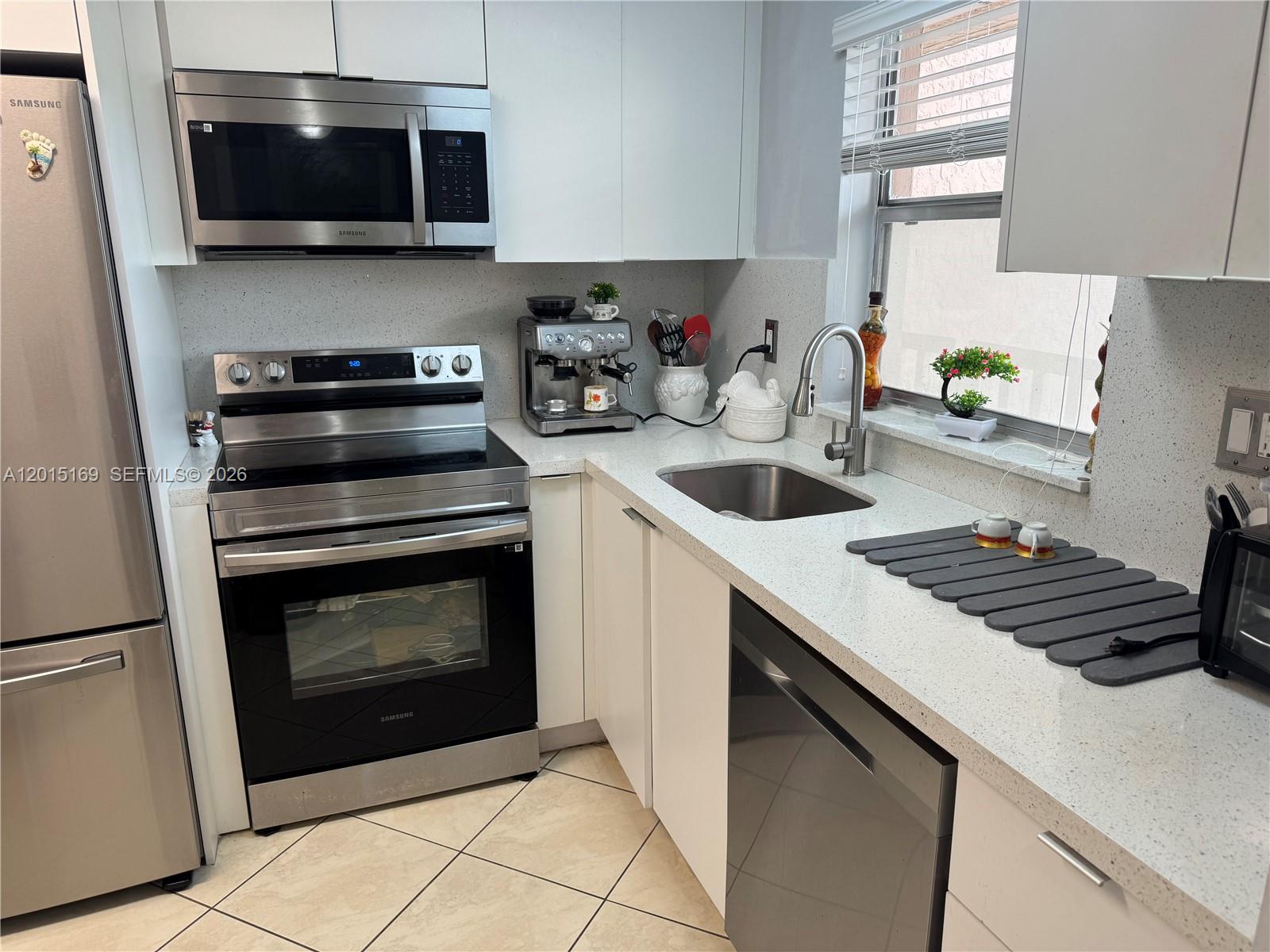 Welcome to this beautifully remodeled and cozy 1-bedroom, 1.5-bath condo with breathtaking lake views, in the prestigious 55+ community of Sunrise Lakes.  This move-in ready unit features a recently renovated kitchen with new cabinets, stainless steel appliances, replaced the electrical breaker panel, and a modern tankless water heater.  Ceramic and vinyl flooring throughout add style and easy maintenance.  Relax on your balcony while enjoying serene water views and a charming tree right outside your window.  Enjoy resort-style amenities including a stunning clubhouse, heated pool & outdoor pool, tennis courts, golf, theater, ballroom, and courtesy bus service.  Excellent location close to shopping, restaurants and major highways. Maintenance includes: water, cable, internet, exterior insurance & landscaping.  Come experience the relaxing Florida lifestyle at its best!