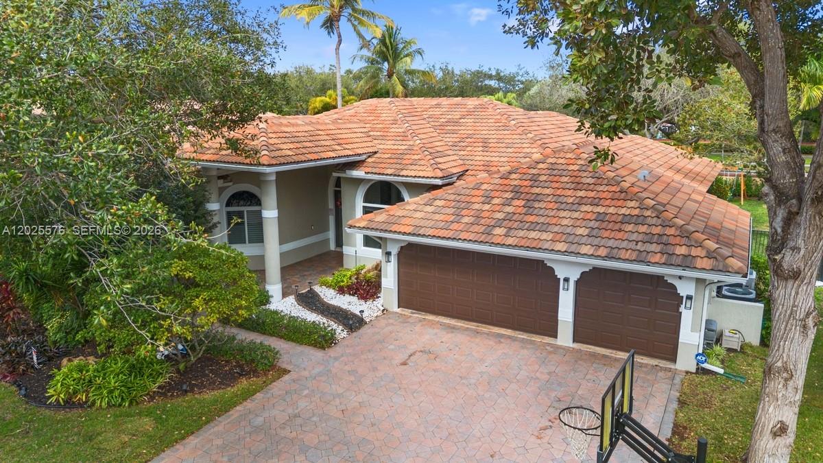Located within the prestigious Isles community with a 24-hour manned gate, this extensively upgraded residence features a sought-after 3-way split floorplan offering privacy and flexibility for families, guests, or a home office setup. 

The home showcases full impact windows and doors, high ceilings, designer lighting, custom wall molding, barn doors, and built-ins throughout. The beautifully updated kitchen includes newer KitchenAid appliances, a wine fridge, and a built-in breakfast nook. 

The expansive primary suite offers a large walk-in closet and spa-style bath with a soaking tub, double vanities, and fireplace. Secondary bedrooms feature updated flooring and crown molding, while the finished garage includes a custom adjustable slat wall system for organized storage. 

Designed for effortless South Florida living, the outdoor space is perfect for entertaining with a heated saltwater pool, outdoor shower, spacious patio, and fenced yard with room to relax or play. A removable pool safety fence is included. 

Move-in ready and impeccably maintained, this rental offers luxury, comfort, and an unbeatable location.