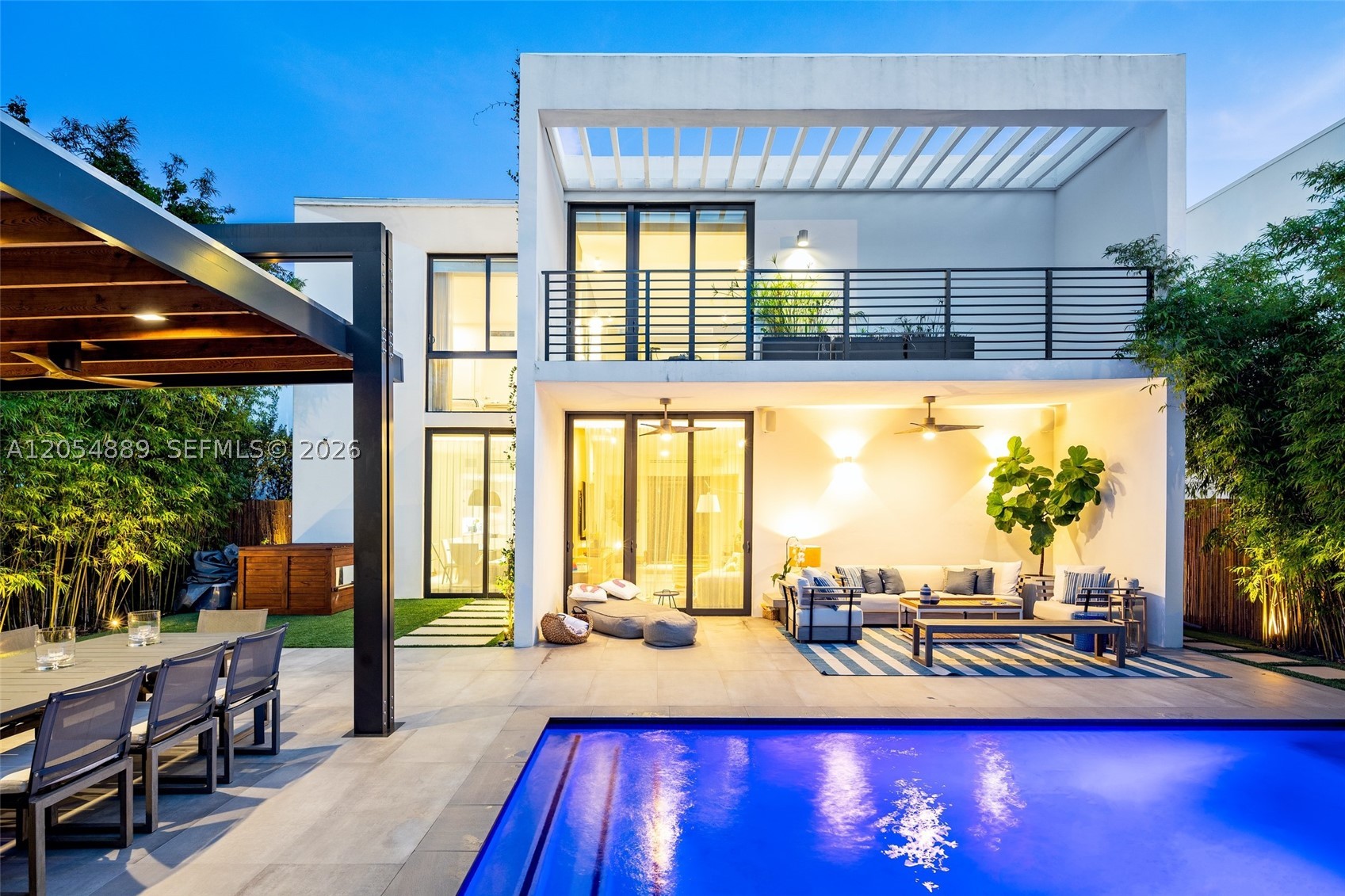Great opportunity to rent in Miami's Upper East Side gated community of Casa Bianca. This is one of only 18 single-family homes in this private enclave. Step inside and instantly enjoy 10-foot ceilings, an open floor plan, and a thoughtfully designed layout featuring 4 bedrooms and 3 full bathrooms. On the main level, one bedroom is currently configured as a home office, complemented by a full bathroom that also serves as a convenient cabana bath. Upstairs, the spacious primary suite is joined by two additional bedrooms connected by a Jack-and-Jill bathroom, offering an ideal layout for family living.
This modern, high-tech home comes fully automated with Control4, allowing you to control the music, motorized blinds, lighting, thermostats, security system, TVs, and more—all from a single app. Enjoy your own private backyard oasis with professionally designed lush landscaping and lighting, a fully equipped outdoor summer kitchen, outdoor shower, and swimming pool. Offered fully furnished. No short-term rentals. Available beginning September 13, 2026.