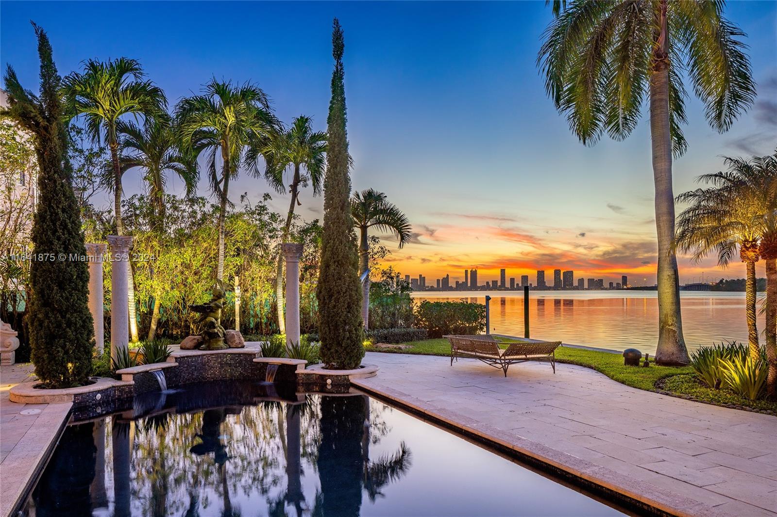 This gated transitional style, 2-story waterfront estate on North Bay Road has undergone a stunning expert renovation using only the finest materials. Sitting on a 20,500 SF lot the 6BR/7+1BA home offers 9,852 total SF. Features soaring ceilings, marble/limestone floors, custom marble/glass staircase, living room w/fireplace, dining room w/wine cellar, family room, bar/game room, all w/amazing water views. Chef’s kitchen boasts top-of-the-line appliances, center island, custom cabinetry & natural stones. Large 2nd floor principal suite with a private terrace & stunning principal bath w/designer walk-in closet. Outdoor highlights: covered seating area, pool, bar/summer kitchen, full cabana bath, 100’ WF, dock w/boat & jet-ski lifts-direct bay access. Truly the Crown Jewel of North Bay Road.