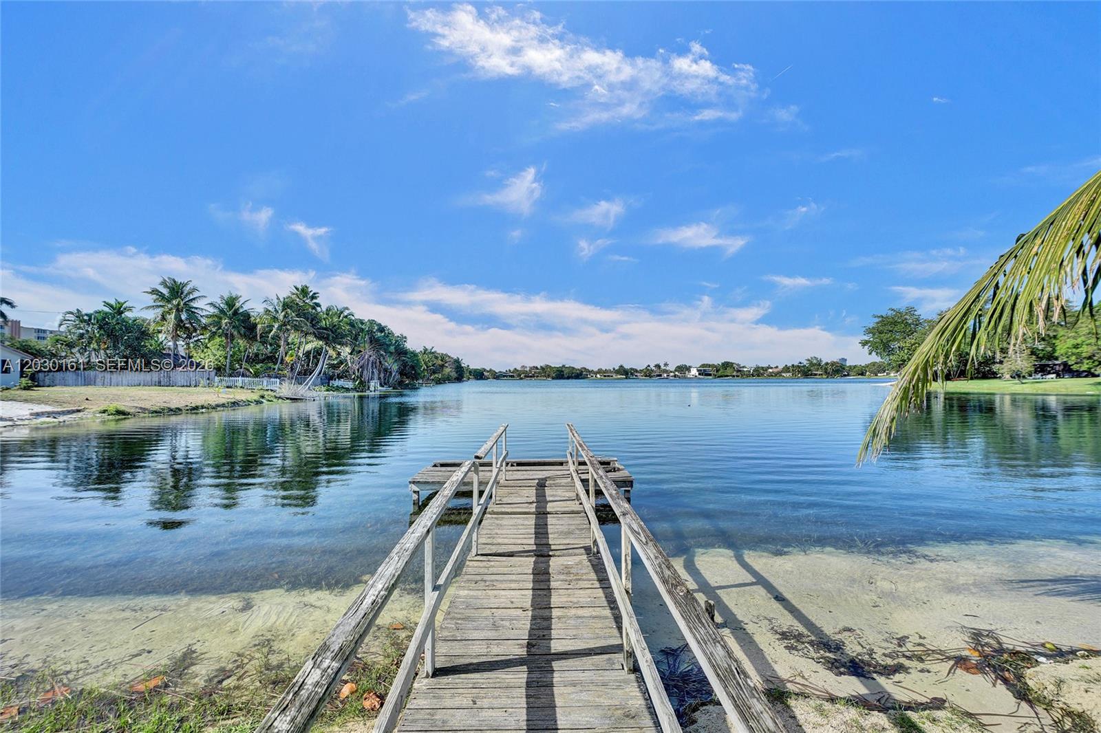 Welcome to this 4-bedroom, 2-bath waterfront home on Greyknoll Lake, located in the highly desirable Skylake neighborhood. This  home sits on a generous stunning 11,723 sqft lot and features an updated kitchen with stainless steel appliances, modern bathrooms, new flooring throughout, a 3-year-old roof, and a brand-new A/C. Enjoy serene lake views from the living area and primary bedroom, or relax on the screened patio with your own private dock. Paddleboard, kayak, or fish right from your backyard. Minutes from Aventura Mall, top dining, and entertainment. This is South Florida living at its best! This beautifully maintained home sits on a generous 11,723 sqft lot and features an updated kitchen with stainless steel appliances, modern bathrooms, new flooring throughout, a 3-year-old roof, and a brand-new A/C. Enjoy serene lake views from the living area and primary bedroom, or relax on the screened patio with your own private dock. Paddleboard, kayak, or fish right from your backyard. Minutes from Aventura Mall, top dining, and entertainment. This is South Florida living at its best!