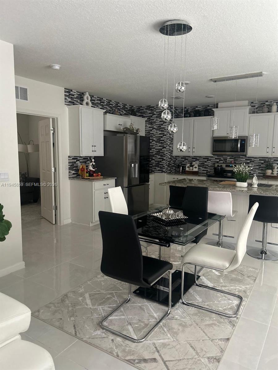 Beautifully upgraded waterfront home featuring porcelain tile flooring throughout and a bright, open-concept layout designed for comfortable living and entertaining. The modern kitchen showcases white cabinetry, granite countertops, stainless steel appliances, a spacious center island, and ample storage. The  light fixtures add a contemporary touch and enhance the home’s natural light.
The home is equipped with a smart house system that allows convenient control of lighting, climate, and security.

The primary suite offers a peaceful retreat with generous closet space and a well-appointed bathroom. Additional bedrooms provide flexibility for guests, a home office, or hobby space.

Step outside to a covered patio with a newly added gazebo, ideal for outdoor dining, relaxing, or enjoying serene water views and Florida sunsets.

Located in a sought-after, amenity-rich community featuring a resort-style clubhouse, elegant gathering spaces, game and entertainment rooms, tennis, pickleball, Basketball, catering kitchen, playground, and a large resort-style swimming pool with sundeck and lounge areas. Conveniently close to shopping, dining, golf, and major highways. Move-in ready and perfectly suited for the Florida lifestyle.