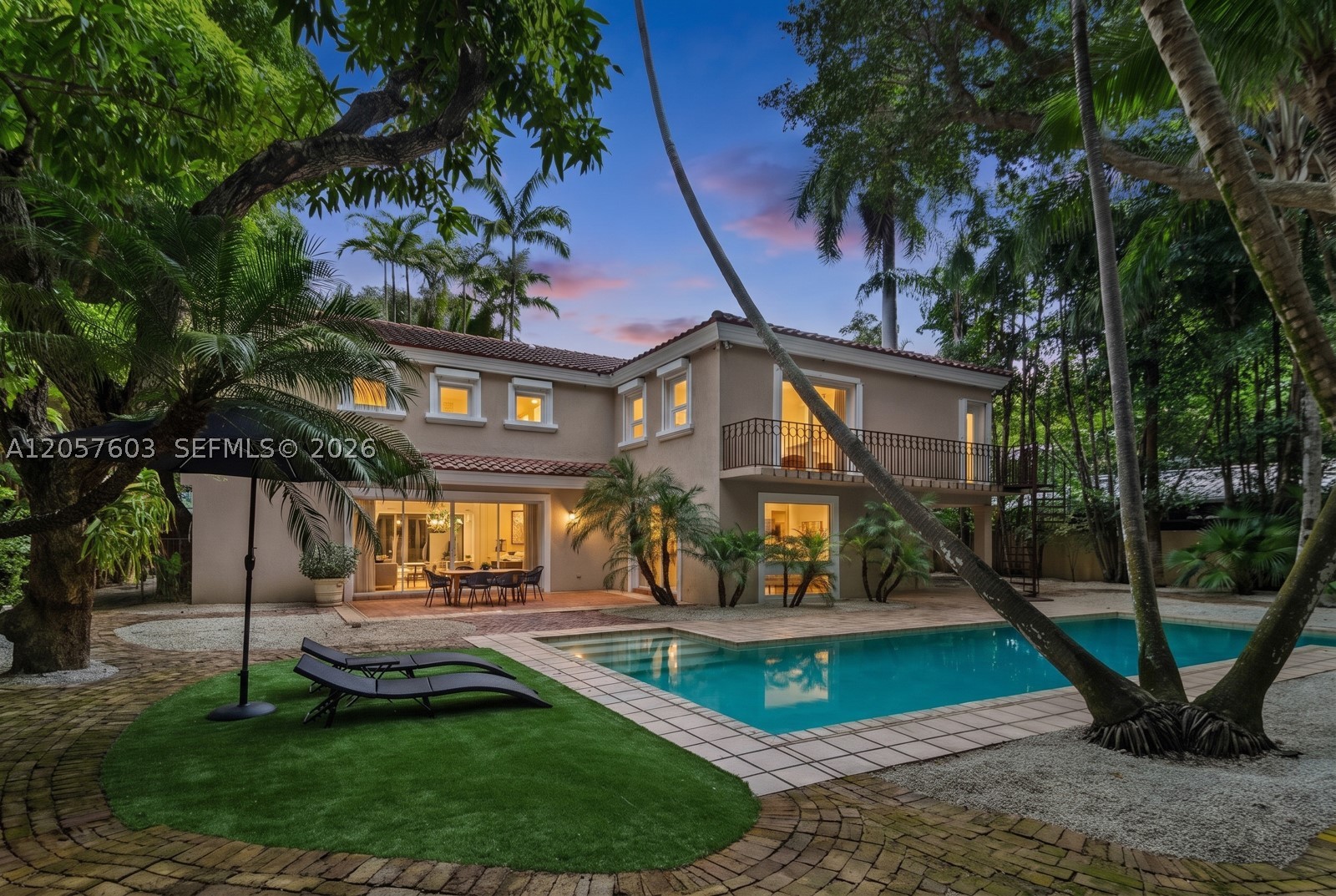 Discover this ultra-private, gated residence nestled within lush tropical gardens, offering a peaceful sanctuary in the heart of South Coconut Grove. Designed for indoor-outdoor living, the home features light-filled open spaces and a dramatic living room with soaring ceilings that open to a courtyard on one side and a resort-style pool surrounded by tropical landscaping on the other. The floor plan includes a spacious family room and dining area, a formal living room, an office/gym/play room, and a large kitchen. Each of the 4 bedrooms has an en suite bathroom, including a luxurious primary suite overlooking the pool and gardens. This exceptional home sits on an oversized 13,490 square-foot lot and is not in a flood zone. Just moments from Coconut Grove’s vibrant village center, restaurants, boutiques, marinas, and scenic bike and running paths. Ideally located near Ransom Everglades and Carrollton Schools and just minutes to Downtown Miami. This is a rare opportunity to enjoy privacy, luxury, and convenience in one of Miami’s most desirable neighborhoods.