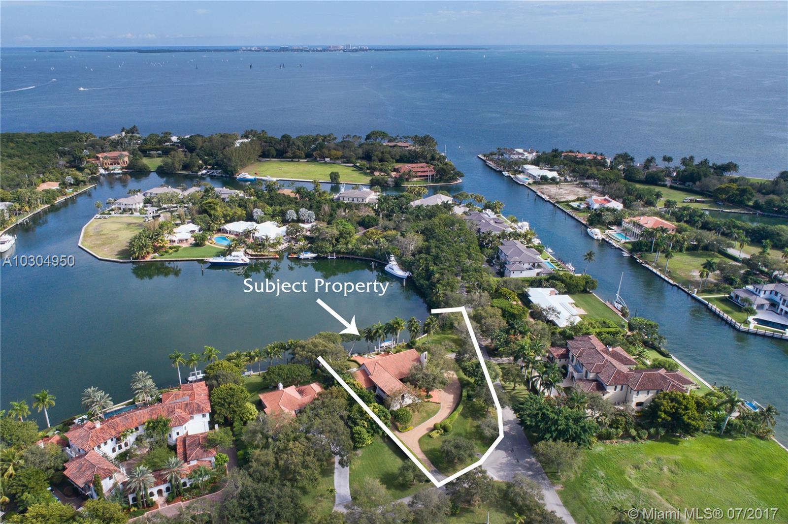 Spectacular views surround this contemporary styled 5 bed  / 5 b home in Gables Estates. This family home features wide water views from the back and a landscaped cul-de-sac centered by the tennis courts from the front. Additional features include a spacious play room, perfect for billiards, movie watching, or large family gatherings as well as a beautifully positioned first floor master suite and office.  Along with a three car garage, there is also a separate covered parking pavilion adjacent to the garage.