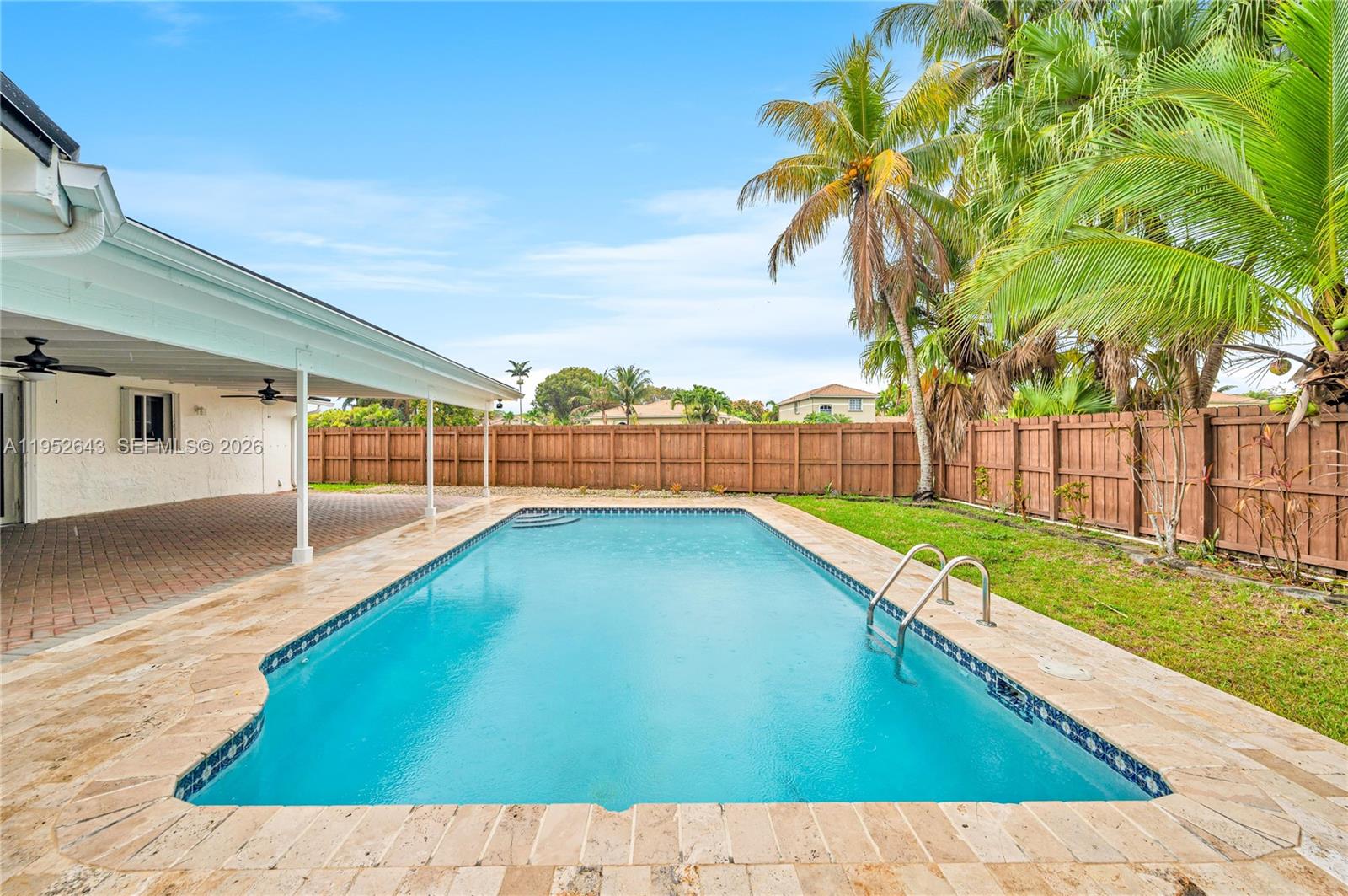 Gracefully renovated and filled with natural light, this inviting home sits on a coveted corner canal lot in Palmetto Bay. The thoughtfully designed layout includes a versatile spare room ideal as a fifth bedroom or private home office. Outdoors, a serene resort-style pool is complemented by an expansive covered brick-paver patio, fully fenced for privacy and  perfectly suited for entertaining or peaceful moments at home. The kitchen is both stylish and functional, featuring white cabinetry, quartz countertops, and stainless-steel Samsung appliances. Additional enhancements include tastefully updated bathrooms, newer roof, A/C, gutters, and electrical panels, accordion hurricane shutters, and lush tropical landscaping adorned with fruit trees. Nearby Top-rated schools, shops and parks.