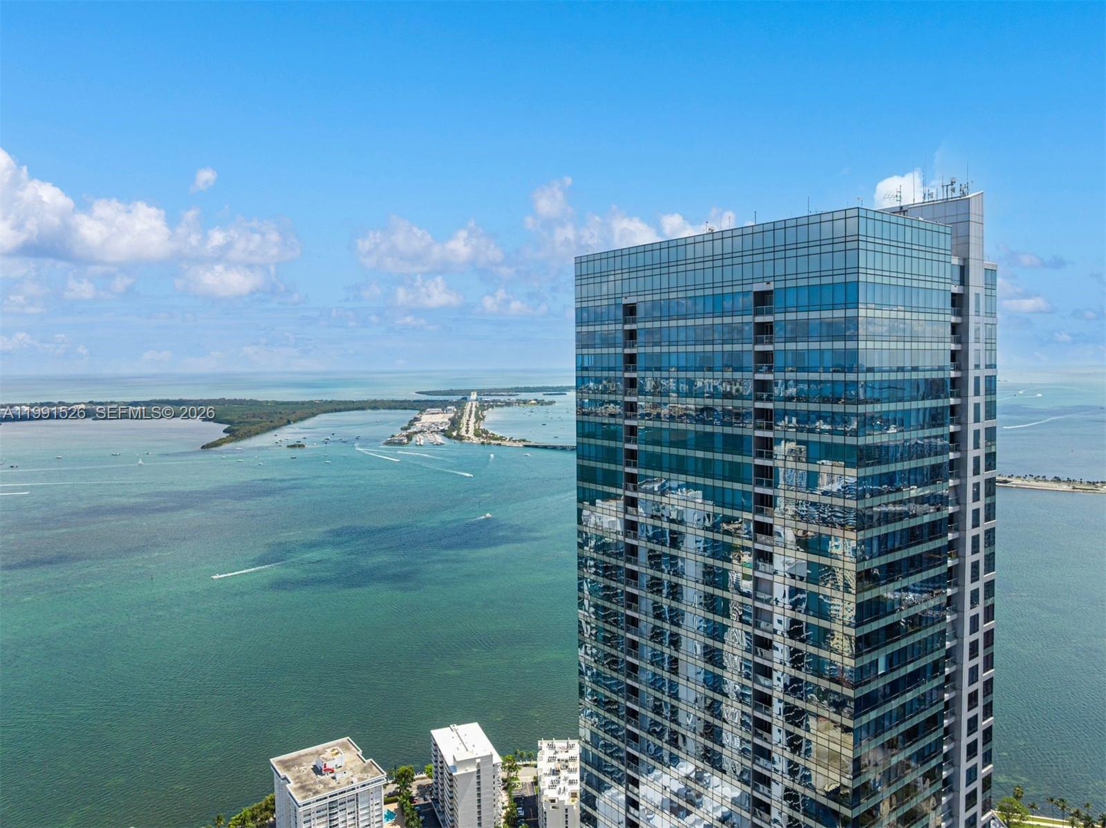One-of-a-kind penthouse at the prestigious Four Seasons Residences in Downtown Brickell, rarely available and offering 6,671 SF of refined living space. Formed by the seamless combination of four units, this extraordinary residence features 4 bedrooms, 4 full baths, and 2 half baths, all designed to capture breathtaking, unobstructed views of the Atlantic Ocean, Biscayne Bay, and the Miami skyline. A grand private elevator foyer opens to expansive living and dining areas wrapped in floor-to-ceiling glass, showcasing spectacular sunrises and sunsets. Interiors are finished with marble and wood flooring, volume ceilings, custom millwork, and an open-concept split-bedroom layout. Highlights include a private movie theater, wine cellar, studio/conference room, and a state-of-the-art chef’s kitchen with Sub-Zero/Wolf appliances, marble finishes, and a striking center island. The principal suite offers a serene retreat with sitting area, private balcony, custom walk-in closets, and a spa-like bath with soaking tub and glass-enclosed shower. Enjoy Four Seasons’ world-class amenities, including multiple pools, Equinox fitness center membership, spa, concierge, valet, and in-residence services. Complete with four parking spaces, private elevator, and storage. A truly exceptional, move-in-ready residence in one of Brickell’s most iconic towers.
