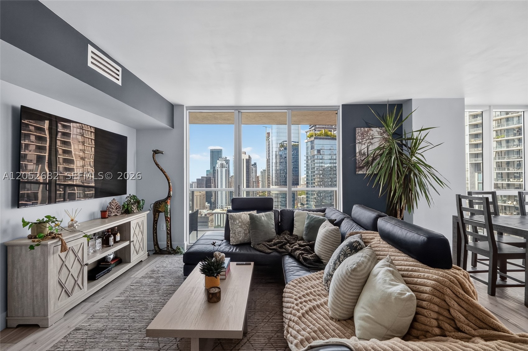 This south-facing corner unit features an extended balcony overlooking Brickell and the Miami River, while also offering views of Biscayne Bay. Floor-to-ceiling impact windows, impact sliding glass doors, and porcelain tile flooring run throughout the unit. The primary bathroom was remodeled with floor-to-ceiling porcelain tile, a freestanding soaking tub, and a custom-built vanity. A custom-built Murphy bed in the second bedroom offers flexibility as a guest room, library, or home office. Both bedrooms include walk-in closets, and the A/C was replaced in 2022 and is equipped with a Nest thermostat. Located across the street from Brickell City Centre and the Miami Metromover, this residence gives convenient access to shopping, dining, and entertainment. Building amenities include a fitness center, resort-style pool deck, rooftop pool, cold plunge, EV charging stations, a 24/7 mini-market, valet, 24-hour front desk service, and on-site security. Combining updated interiors, expansive views, and a prime Brickell location, this residence offers the convenience of city living.