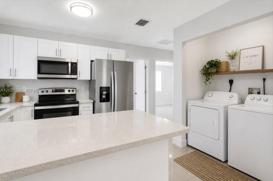 WATER & LIGHT INCLUDED!! LOW MOVE IN COST! Beautifully designed 3-bedroom, 2-bathroom unit available for rent in a newer construction building (2023). This modern home features a bright, open layout with high-end finishes throughout and impact windows for added safety and energy efficiency. The kitchen showcases sleek white cabinetry, and quartz-style countertops, complemented by stainless steel appliances and ample prep space, perfect for both everyday living and entertaining. The open-concept design flows seamlessly into the main living area, creating a light and inviting atmosphere.
Both bathrooms offer a contemporary feel with modern vanities, large-format tile, and walk-in showers. The finishes are clean, bright, and thoughtfully designed to give a fresh, spa-like appearance.
A dedicated in-unit laundry area includes a washer and dryer, enhanced with a clean, functional layout that blends style and convenience. This unit offers the perfect combination of modern design, comfort, and practicality.