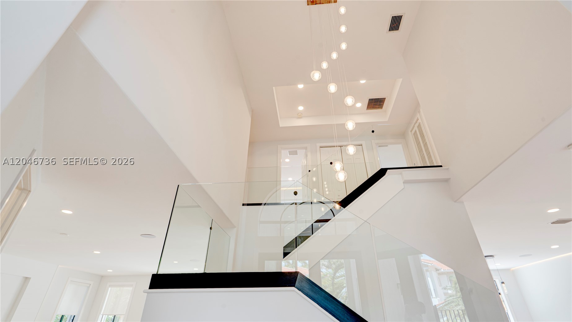 STUNNINGLY Renovated luxury home with high-end finishes, designer details, premium smart-home features throughout. This exceptional residence offers a modern, light-filled design w/everything completely new, combining contemporary elegance with comfort, functionality and resort-style outdoor living. Main Features are: Fully newly renovated with luxury finishes & equipment throughout; Bright, modern interior with light tones & warm wood accents; Waterproof luxury vinyl flooring; Contemporary glass staircase; In-ceiling ambient LED light strips in every room; In-ceiling speaker installation; Kasa smart dimmer switches throughout the home, controllable via Alexa; Separate guest house w/ private bathroom; Beautiful pool area w/ lush tropical landscaping; Tikki Hut tropical patio lounge; Designer kitchen w/ premium finishes & thoughtful custom details: Thick marble countertops; Light-color palette with elegant wood elements; Large kitchen island w/ integrated LED lighting; Induction cooktop with hood; Soft-close cabinetry throughout w/ BLUM hinges; High-end interior cabinet drawer organization for cutlery, spices & more; LED-lit shelving; Wine cooler; Luxury bar sink with premium accessories, including waterfall faucet, cutting board; Spacious pantry w/ ample storage & Motion-sensor shelf lighting, all bathrooms have Floating vanities- Primary has double; LED vanity mirrors; Marble showers w/ glass enclosures; Smart toilets w/heated seats, automatic flush,  2 New Central A/C Units