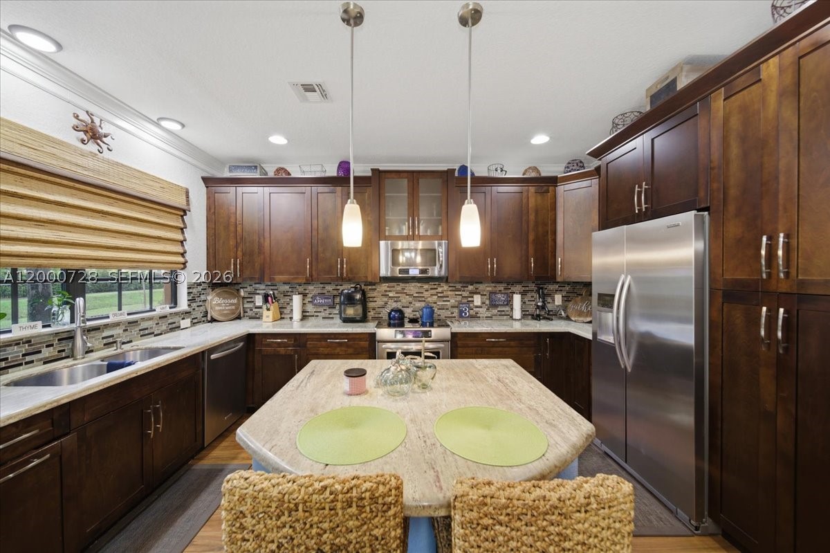 Corner townhouse in gated Riverwalk at Lago Mar with 3 bedrooms, 2.5 baths, an open loft, and a 2-car garage. Built in 2013 and well maintained by the original owner, this home features impact windows and doors, a screened patio, private canal-front setting, upstairs laundry, and a 2024 A/C. The oversized kitchen offers wood cabinetry, granite countertops, a center island, and great flow into the living and dining areas. Upstairs you’ll find generous bedroom sizes, a spacious primary suite, and flexible loft space for office, media, or play. Community amenities include pool and clubhouse, with convenient access to schools, shopping, dining, and major roads.