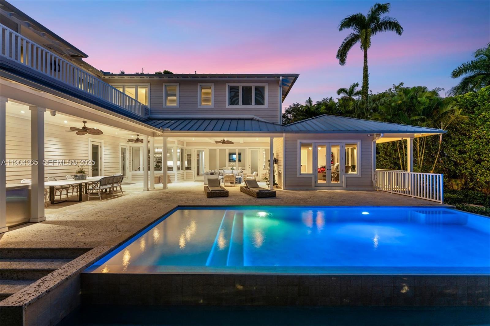 Set on prestigious Sunset Island II, this 2016 ground-up, custom-built residence—designed by award-winning architect David Johnson—offers 4 ensuite bedrooms, a media/pajama lounge with wet bar, 2 private offices, and a flexible gym that can easily convert to a fifth bedroom. Bathed in natural light, the living spaces include a gourmet eat-in kitchen with Calacatta marble island, flowing seamlessly to the family room and a heated infinity pool with expansive covered terrace and summer kitchen. The opulent primary suite boasts a private balcony, spa-inspired bath, and custom walk-in closet. With Sonos, Lutron lighting, Wolf/Sub-Zero appliances, coffered ceilings, 10” oak floors, gated entry, lush landscaping, and a 60kW generator, this home embodies refined, effortless island living.