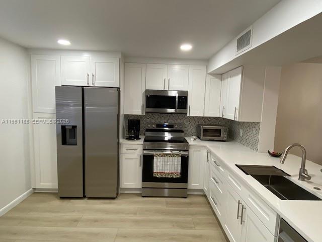Fall in love with this beautifully remodeled 2/2 first-floor condo located in a highly desirable 55+ community. Step into a bright, open kitchen featuring quartz countertops, stainless steel appliances, and elegant white cabinets extending to the ceiling—perfect for cooking and entertaining. New vinyl flooring flows throughout the apartment (except the primary shower area), creating a modern and inviting atmosphere. Both bathrooms have been tastefully updated with new tile flooring, quartz countertops, stylish fixtures, and mirrors. The primary bathroom features double sinks and a beautifully tiled walk-in shower, offering a spa-like experience at home. Relax and unwind on your enclosed balcony with windows, just steps from the pool—it truly feels like your own private retreat. Enjoy resort-style living with multiple pools, pickleball and tennis courts, a fitness center, theater, courtesy bus, and beautifully landscaped walking paths. Stay active, social, and entertained with a full calendar of community activities. Ideally located near The Promenade, Coconut Creek Casino, shopping, and dining, with easy access to I-95 and the Florida Turnpike. And best of all, the beach is just 20 minutes away. This is more than a home—it’s a lifestyle. Come experience it for yourself.