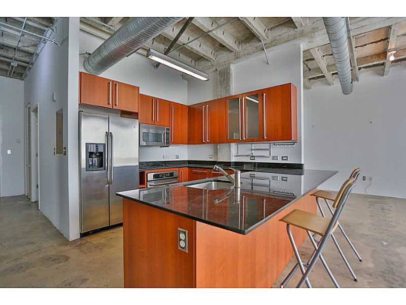 Gorgeous industrial loft w/ fabulous green tree top east views and partial bay views. Floor to ceiling windows for plenty of light. Exposed high beam ceilings! Modern Black Granite countertops, State of the art stainless steel appliances, stained concrete  floors, open and spacious feel. Dishwasher, washer @ dryer in unit. Rooftop jacuzzi w/ wow views! Very well run  building in the heart of the Mimo district. 5 minute drive to Beaches, 5 minutes to Wynwood. Check out video https://youtu.be/lcwrsZpzFts