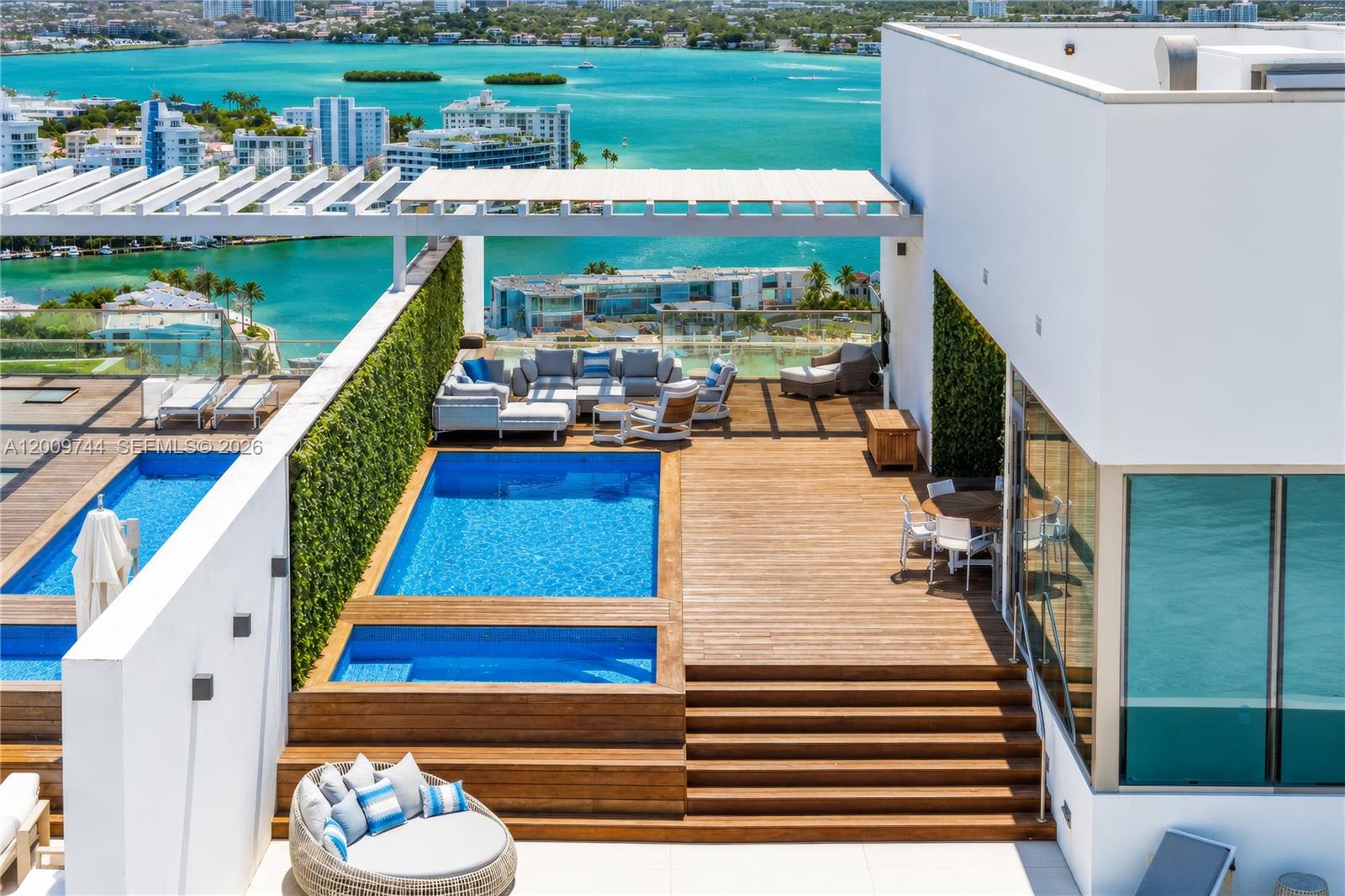 Rare two-story upper PH in Bal Harbour's most coveted tower. 5,000 sq ft under air with intracoastal views and a 1,620 sq ft wrap-around terrace. Private interior elevator leads to a 4,400 sq ft rooftop terrace boasting ocean and intracoastal views, full pool, jacuzzi, summer kitchen, and outdoor living room — the ultimate entertaining space.  13.5 ft floor-to-ceiling windows, 4 bedrooms, 5.5 baths, plus staff room. Professionally designed white marble floors, custom millwork, Gaggenau appliances, custom cabinetry. 4 parking spaces and 2 storage units under A/C.  Oceana Bal Harbor spans 5.5 oceanfront acres with 2 tennis courts, restaurant, concierge, spa, gym, party room, valet, and beach service.  Beach path outside your door.  Walking distance to Bal Harbour shops, close to MIA and FLL airports.