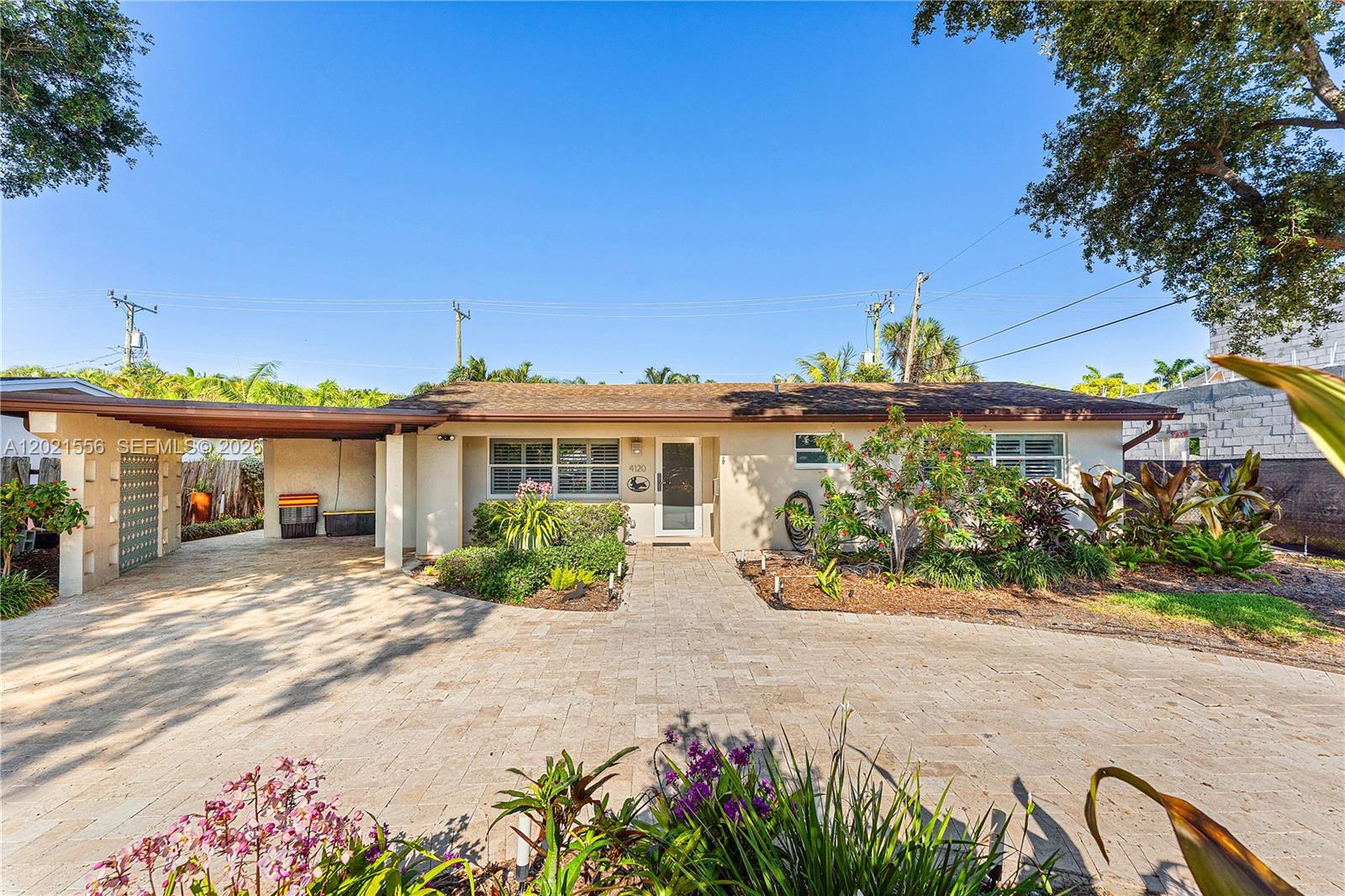 Welcome to this stunningly updated 3-bedroom, 3-bathroom home in the highly sought-after Coral Heights neighborhood of Oakland Park. Designed for effortless living and entertaining, the open floor plan features high ceilings, crown molding throughout, and polished porcelain tile floors. At the heart of the home is a chef’s kitchen boasting granite countertops, an island, stainless steel appliances, and a gas stove, with a cozy breakfast nook overlooking the private backyard oasis.

This rare layout offers TWO split primary suites, both complete with walk-in closets, carpeted floors, and spa-style bathrooms. The main primary suite elevates the luxury with a custom double shower and dual sinks.

Step outside to a fully landscaped, resort-style backyard featuring a heated swimming pool. Elegant ivory travertine tile surrounds the pool deck and extends seamlessly to the walkways, the large circular driveway, and the covered carport. The exterior is an entertainer's dream, complete with a dedicated gas hook-up ready for a custom outdoor kitchen and a 4-zone automated sprinkler system.

Modern, turnkey infrastructure provides ultimate peace of mind: full impact doors and windows, an on-demand tankless water heater, gas dryer, an integrated camera system, and a fast EV charger. As a great advantage for Florida living, the property resides on the Holy Cross Hospital priority power grid!