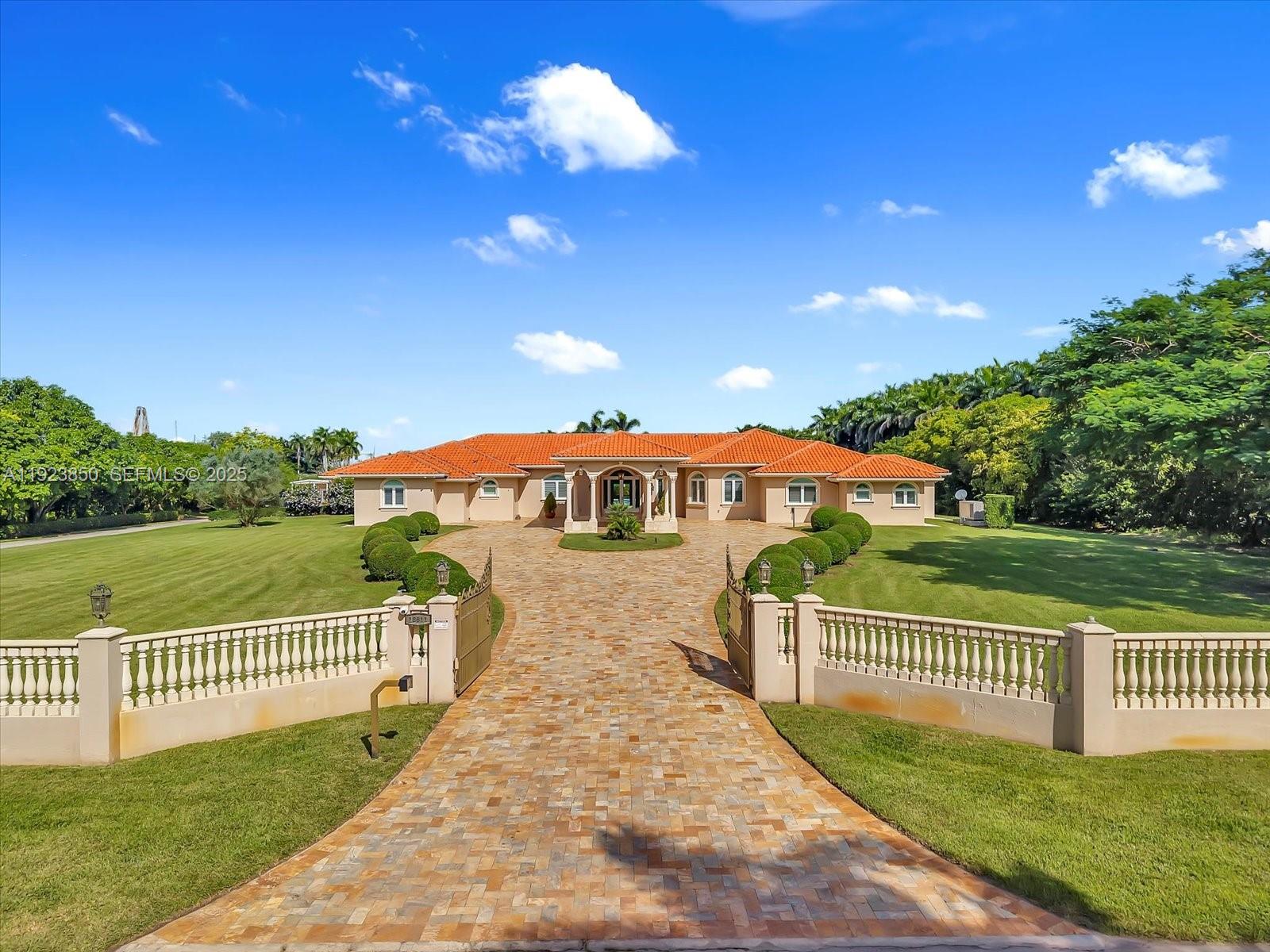 Welcome to this exquisite gated Mediterranean estate in highly sought after West Kendall, offering 5,405 sq ft of refined living space, including 5 bedroom suites—each with its own private bathroom. This elegant single-story residence impresses from the moment you arrive with its grand paver driveway, manicured landscaping, and stately architecture. The property features a detached two-car garage and an inviting cabana complete with a full outdoor kitchen, creating the perfect setting for entertainment and resort-style living. Inside, spacious living areas, high ceilings, and abundant natural light enhance the home’s timeless appeal. Nestled in a private, lush setting and centrally located near top-rated schools and major conveniences, this is a rare opportunity to own a true Miami luxury estate.